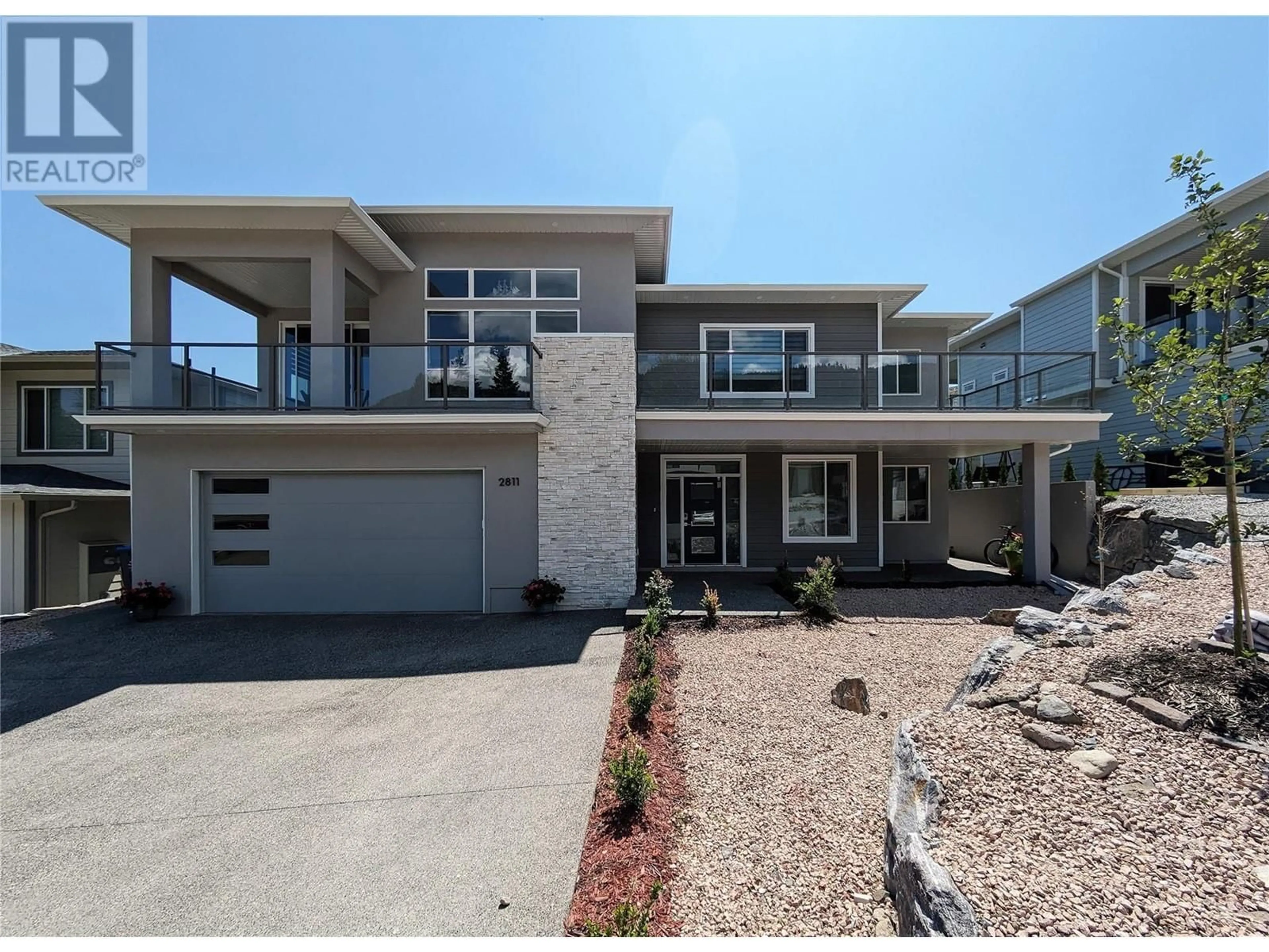 Home with vinyl exterior material, street for 2811 Canyon Crest Drive, West Kelowna British Columbia V4T0E3