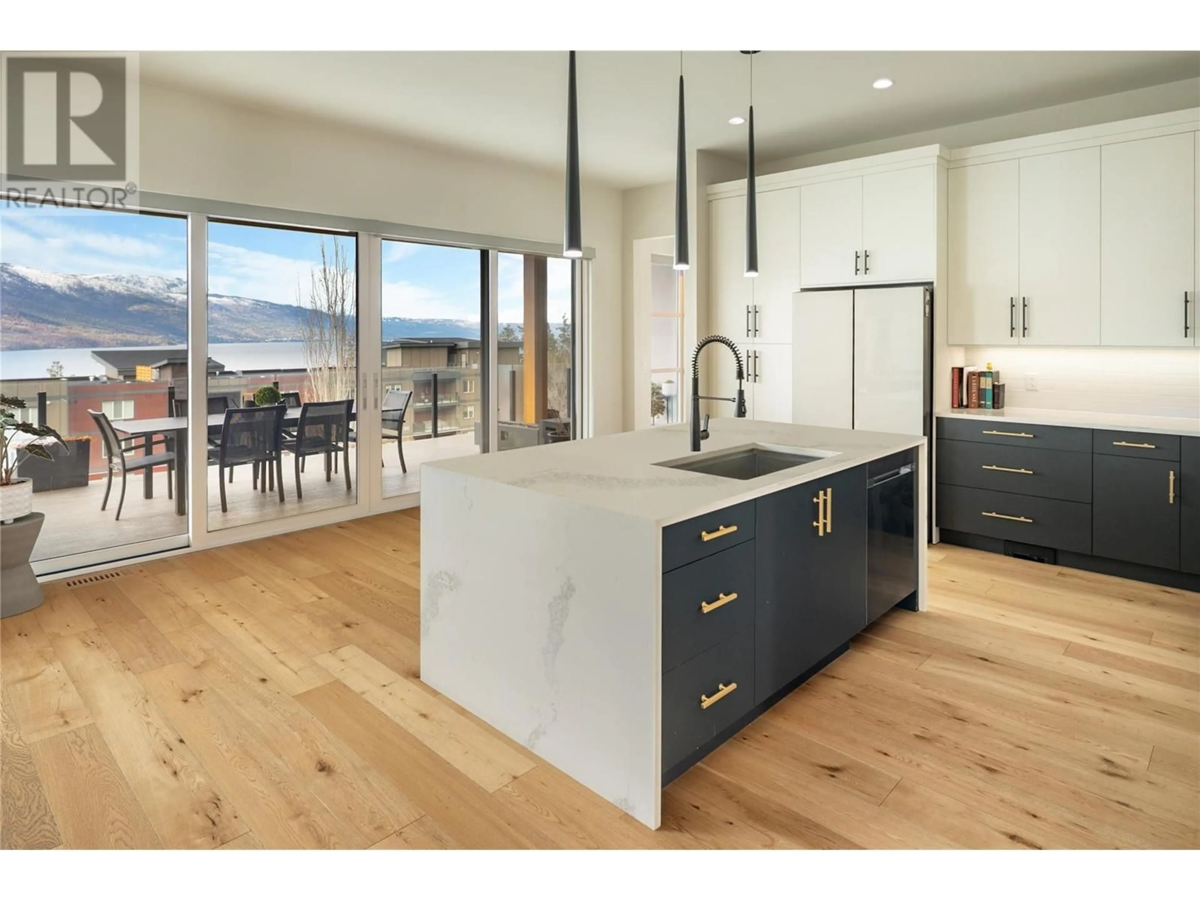 Open concept kitchen, wood/laminate floor for 3450 Chocolate Lily Lane, Kelowna British Columbia V1V3G2