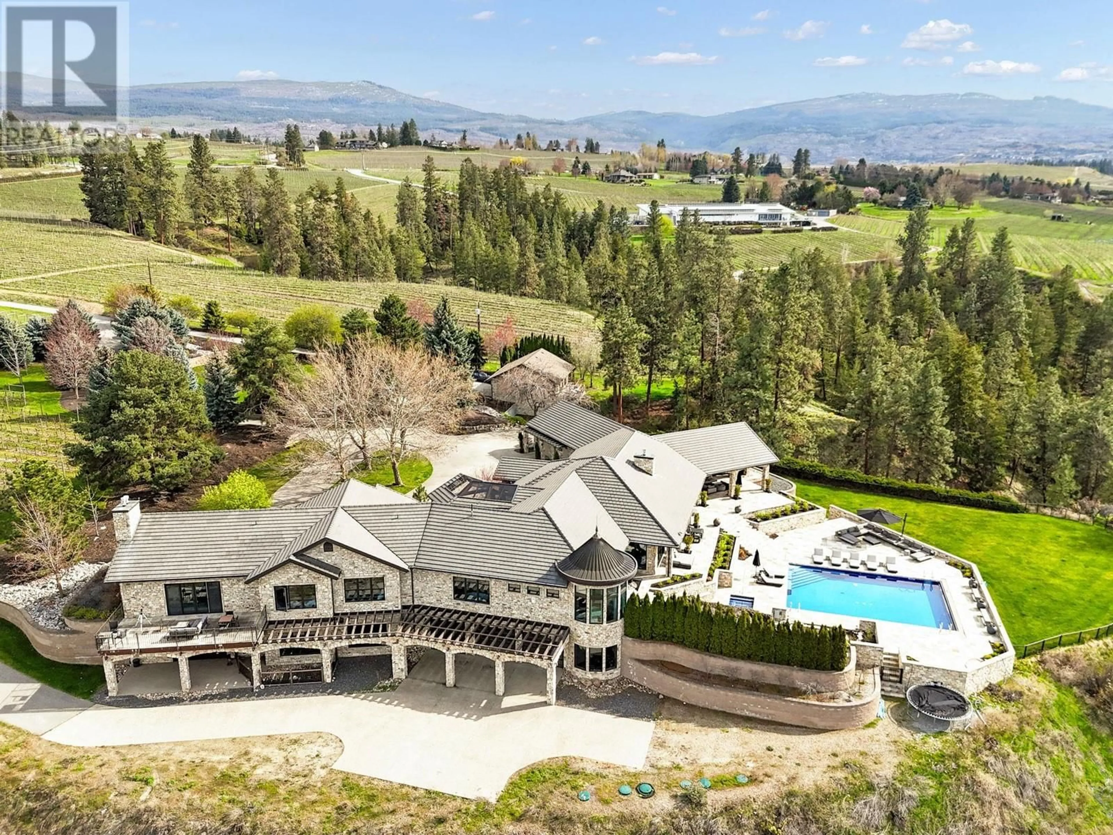 A pic from outside/outdoor area/front of a property/back of a property/a pic from drone, mountain view for 4040 Casorso Road, Kelowna British Columbia V1W4N6