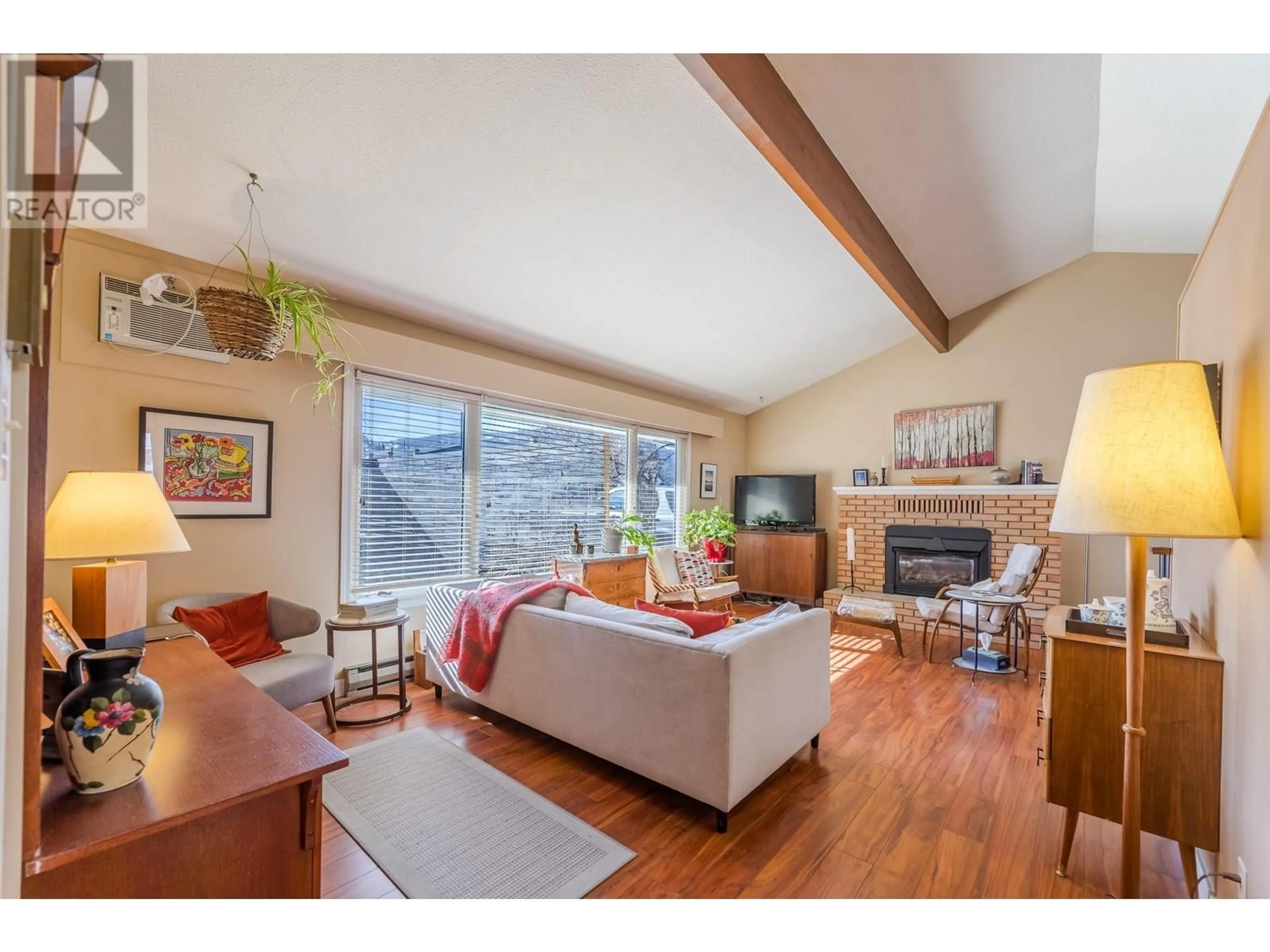 Living room with furniture, wood/laminate floor for 10114 PRAIRIE VALLEY ROAD, Summerland British Columbia V0H1Z0