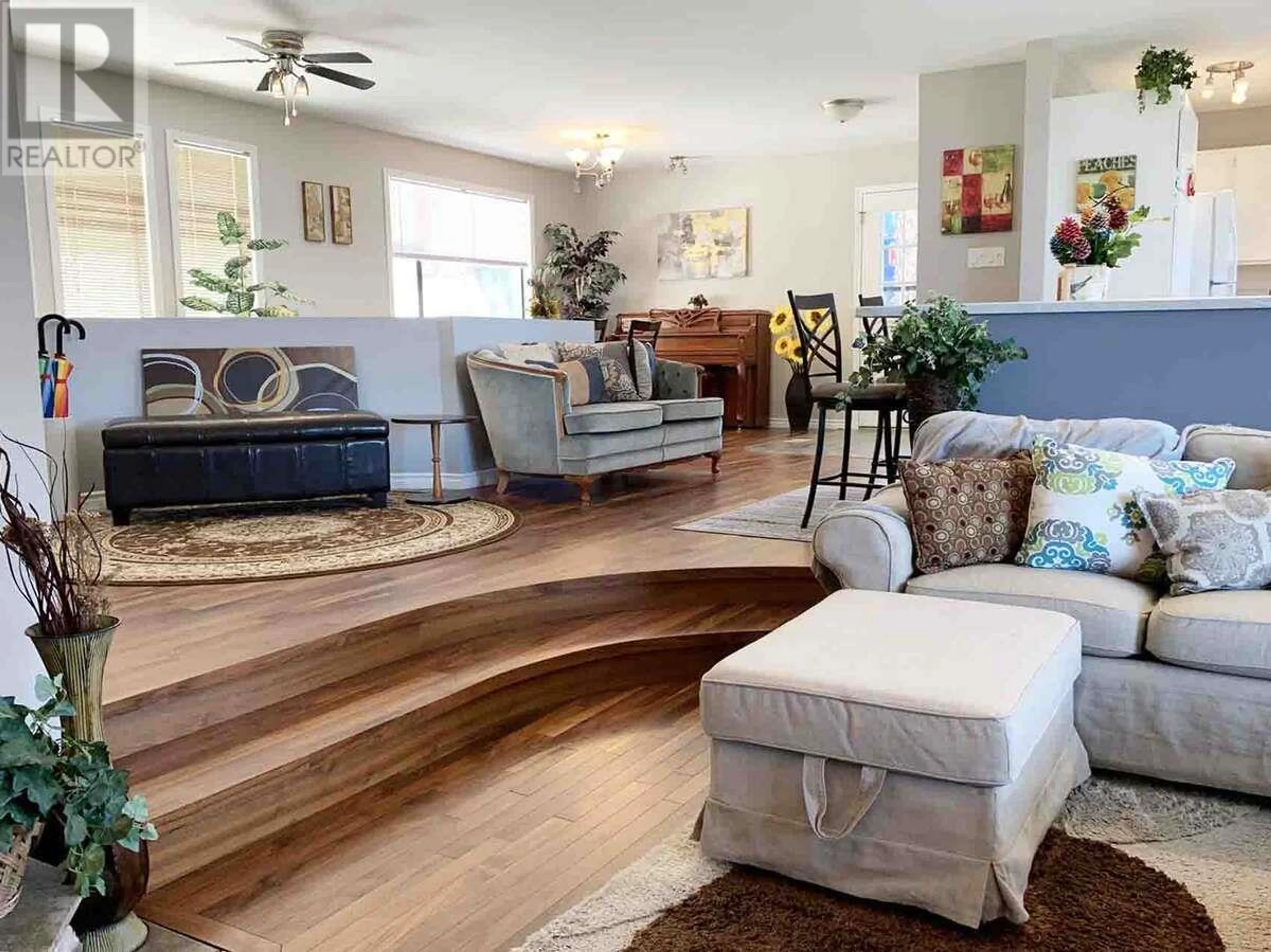 Living room with furniture, wood/laminate floor for 5821 ATKINSON CRESCENT, Peachland British Columbia V0H1X4