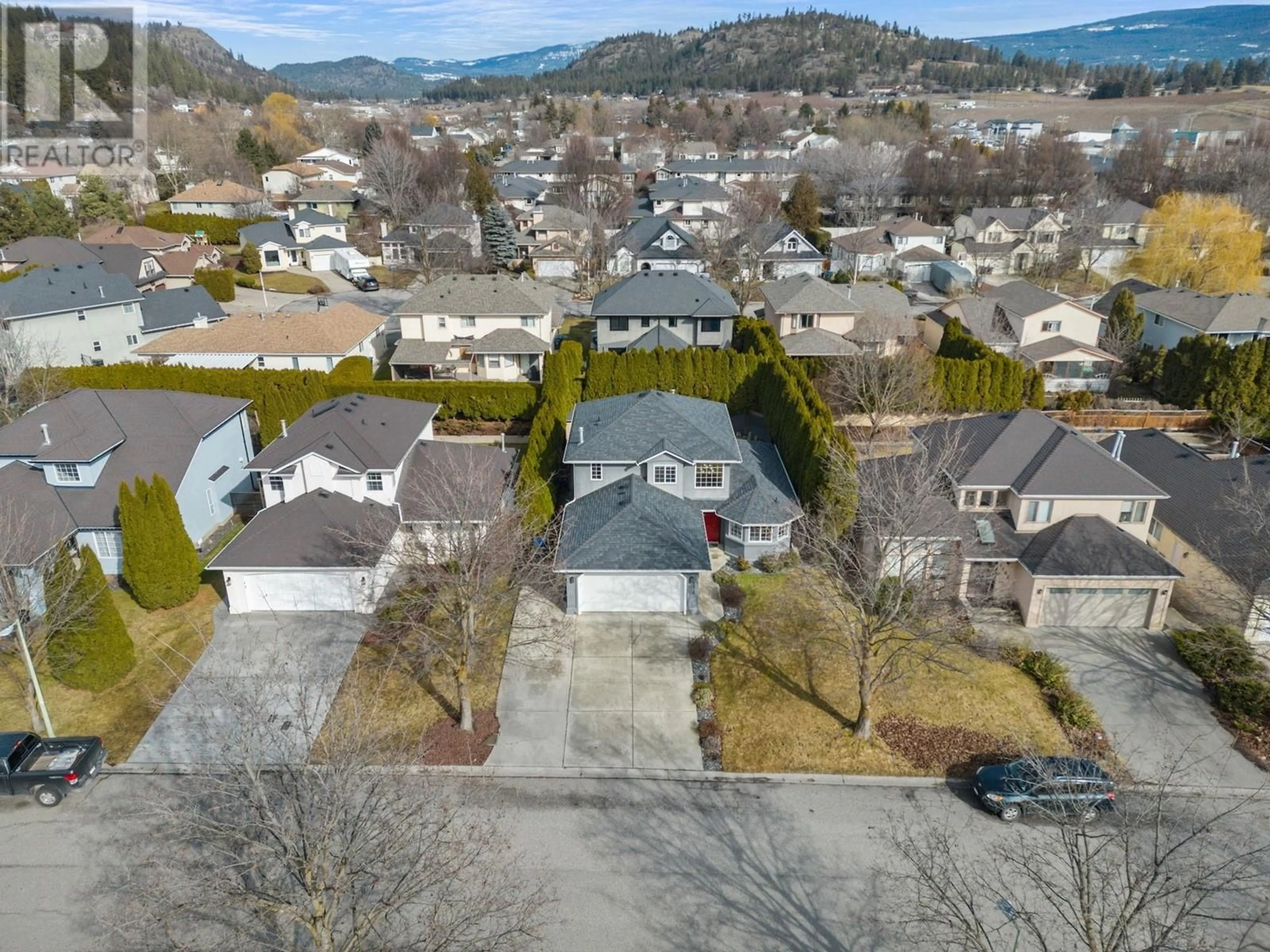 A pic from outside/outdoor area/front of a property/back of a property/a pic from drone, mountain view for 1876 Porthill Drive, Kelowna British Columbia V1V1R9