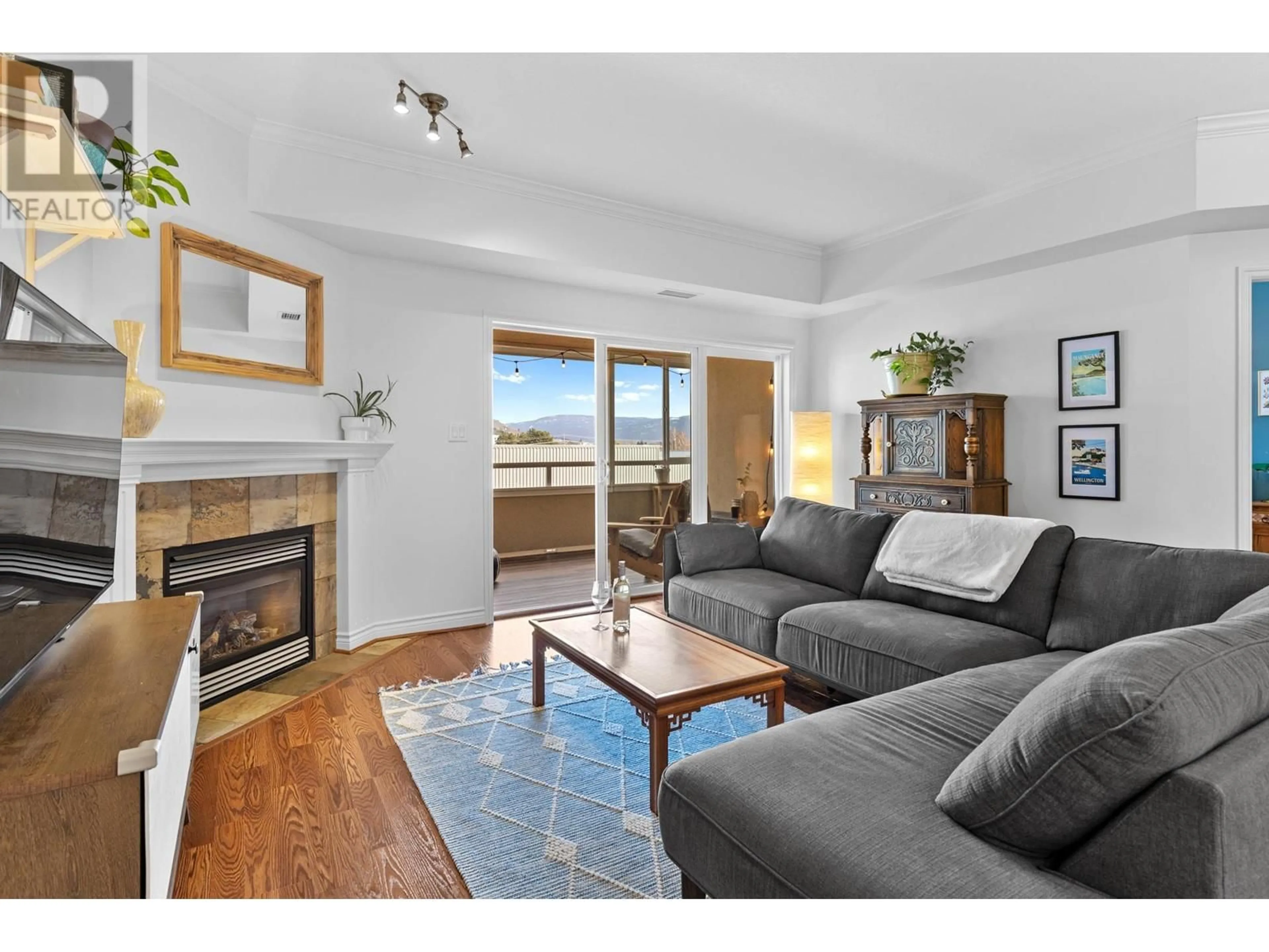 Living room with furniture, wood/laminate floor for 1961 Durnin Road Unit# 403, Kelowna British Columbia V1X7Z6