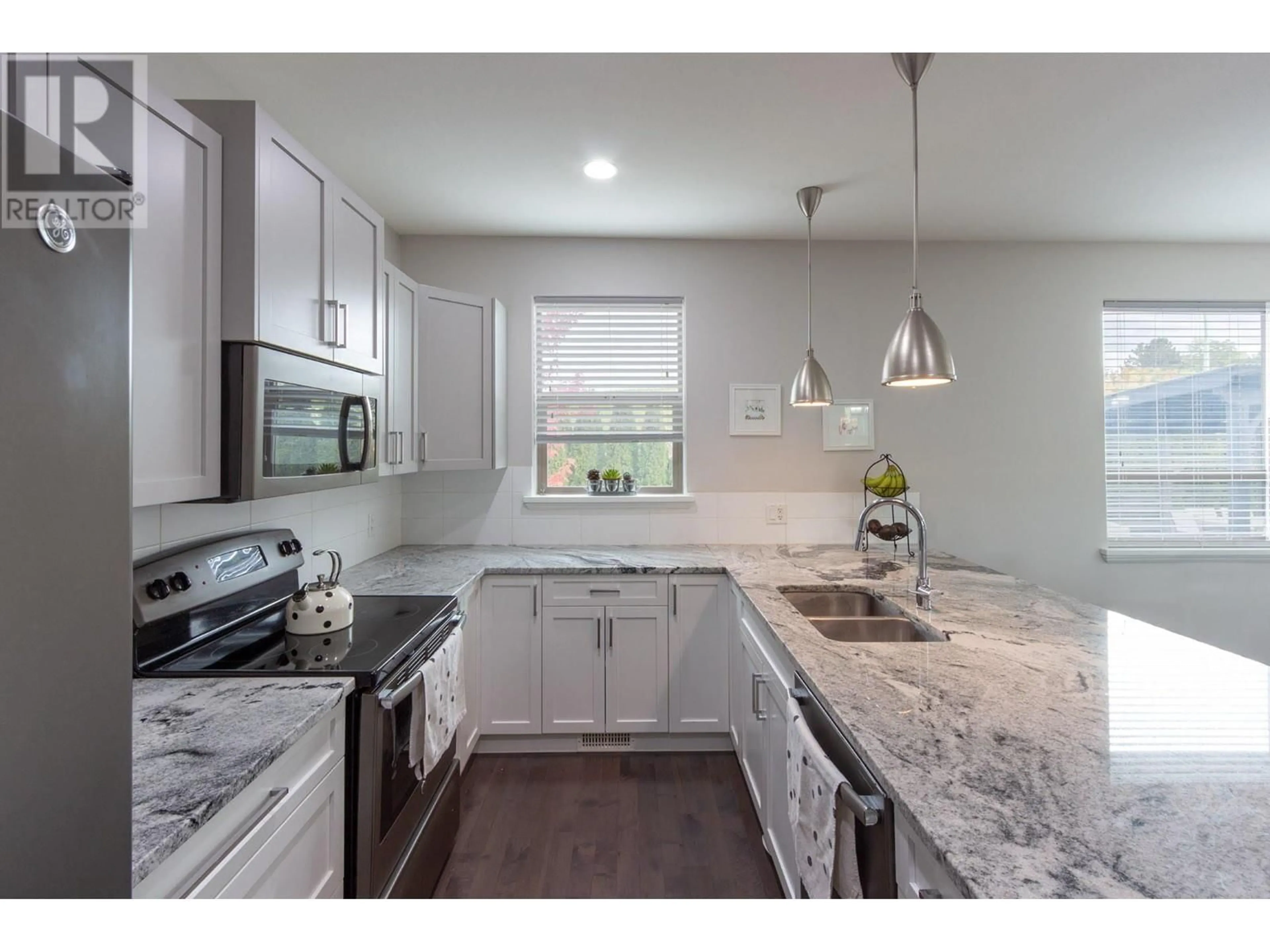 Open concept kitchen, ceramic/tile floor for 1942 Henkel Road, Kelowna British Columbia V1V2E3