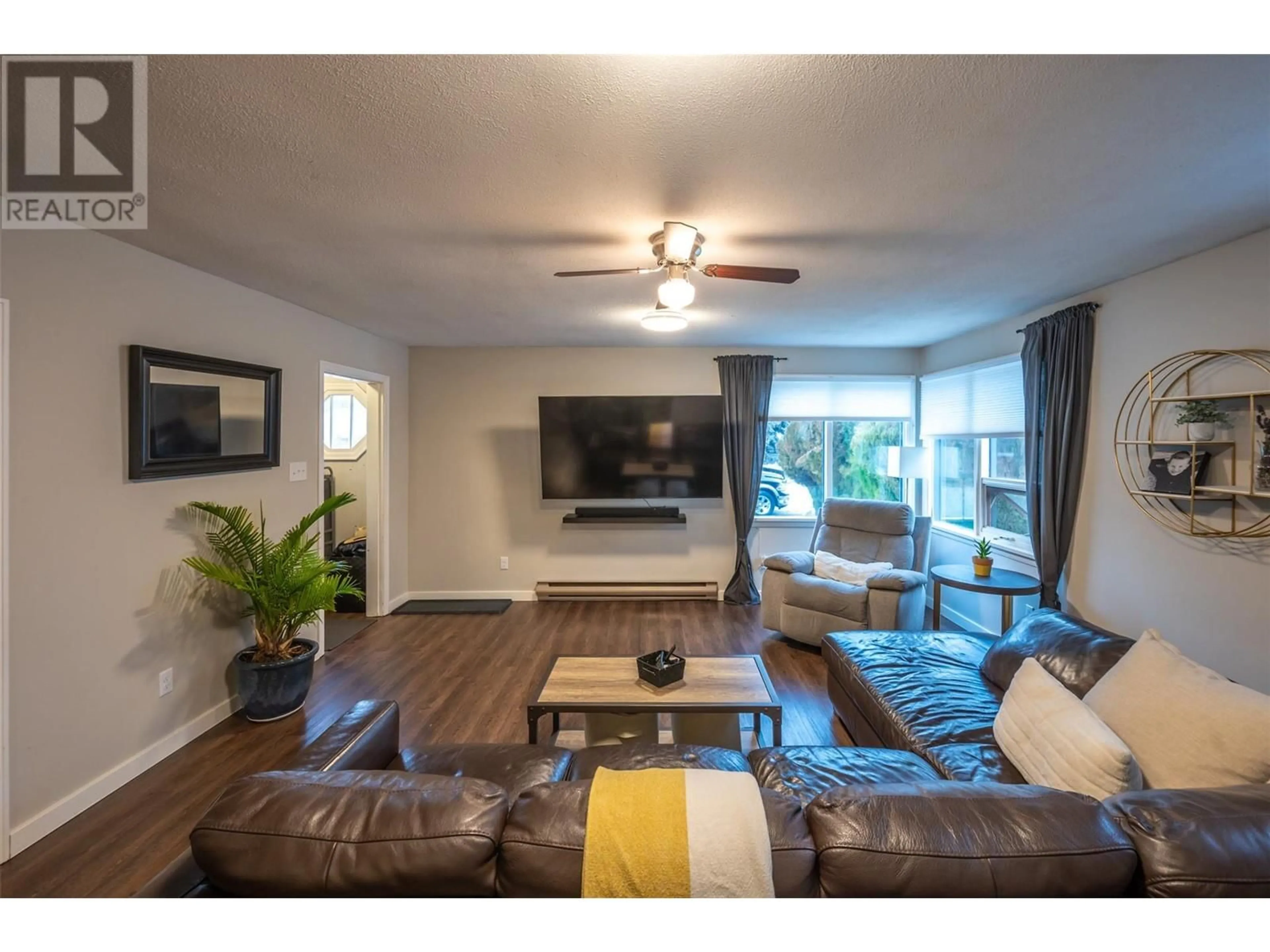 Living room with furniture, wood/laminate floor for 1070 Forestbrook Drive, Penticton British Columbia V2A2G3