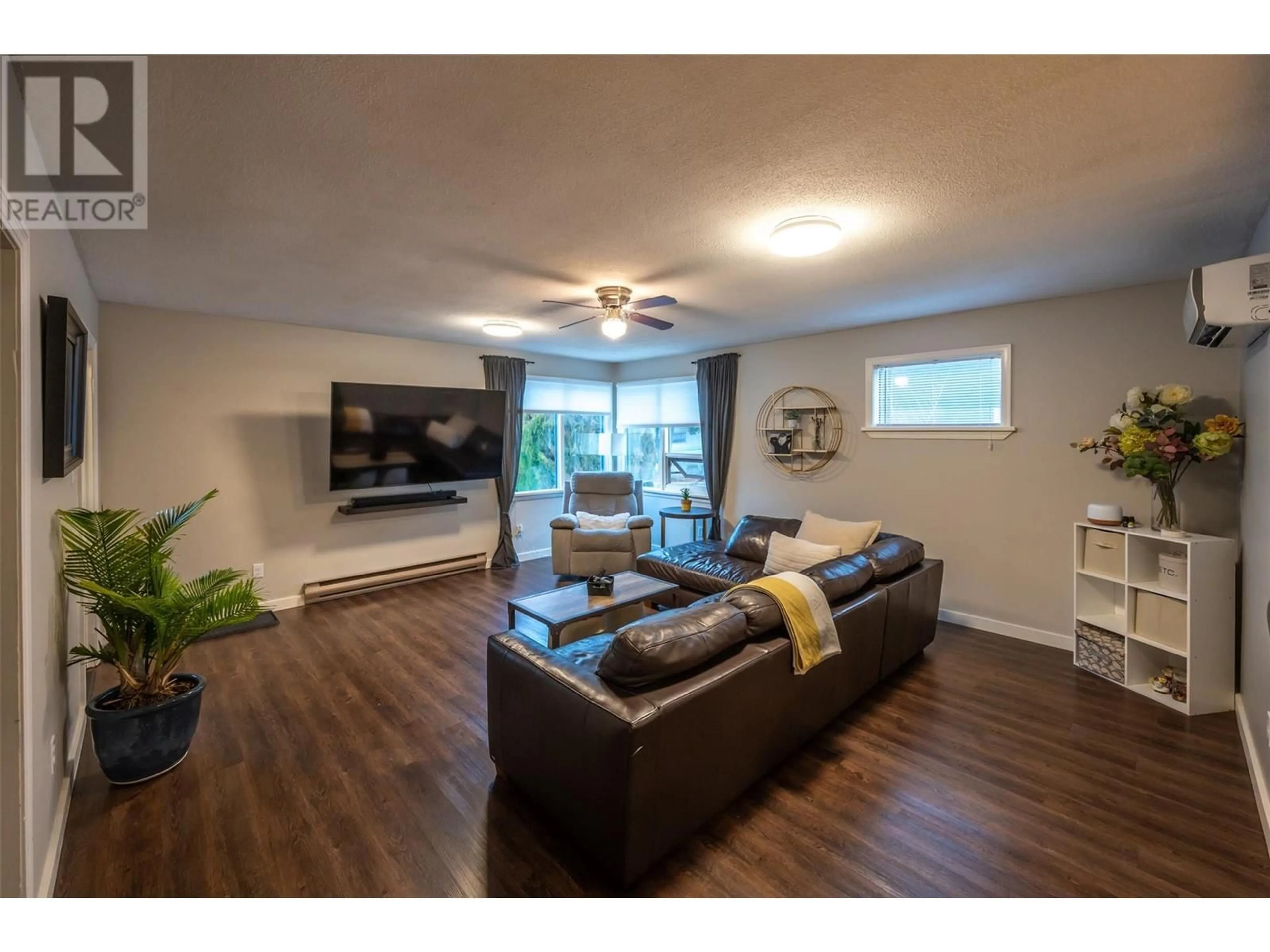 Living room with furniture, wood/laminate floor for 1070 Forestbrook Drive, Penticton British Columbia V2A2G3