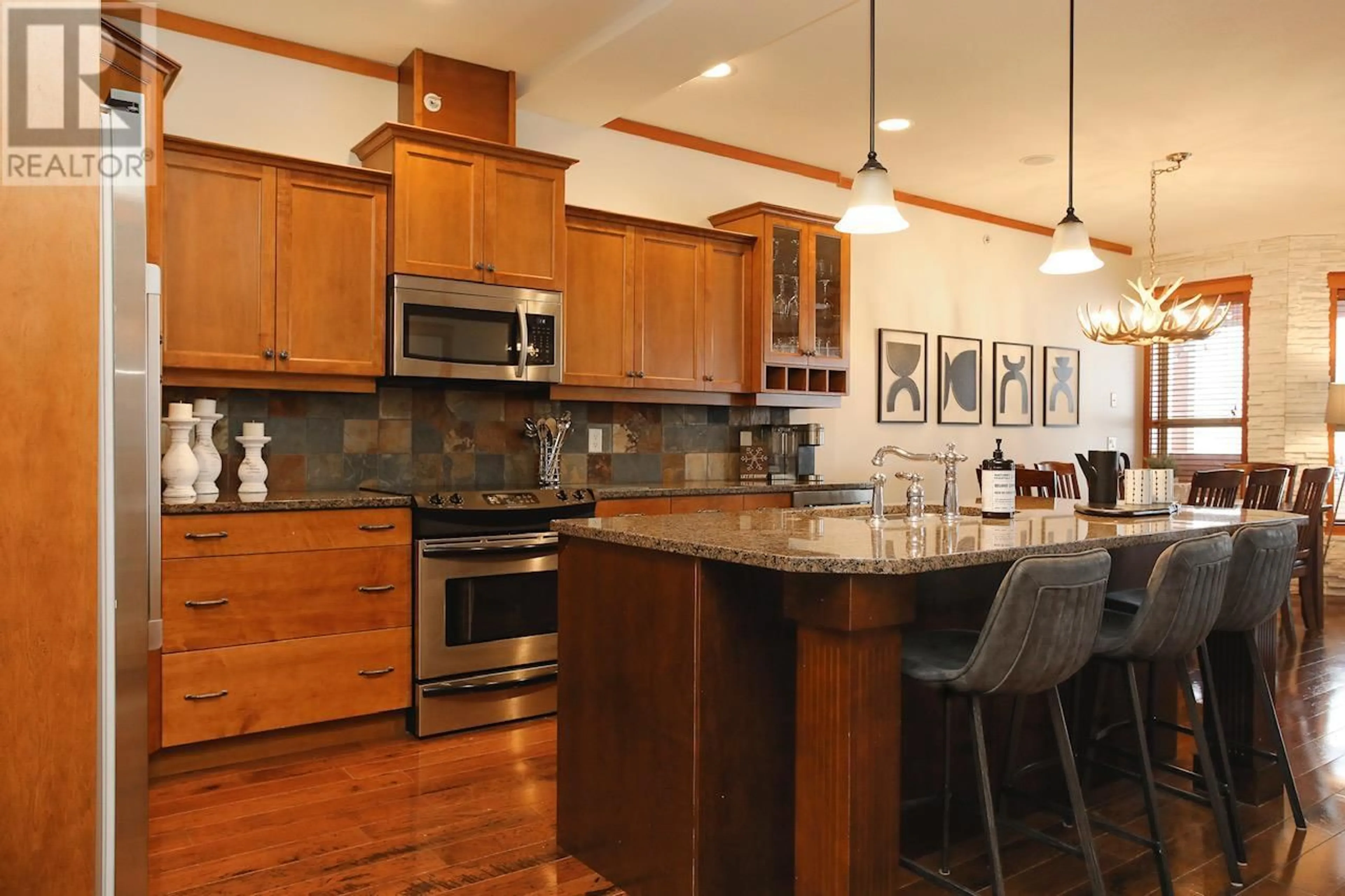Open concept kitchen, wood/laminate floor for 405 - 5050 SNOWBIRD WAY, Big White British Columbia V1P1P3