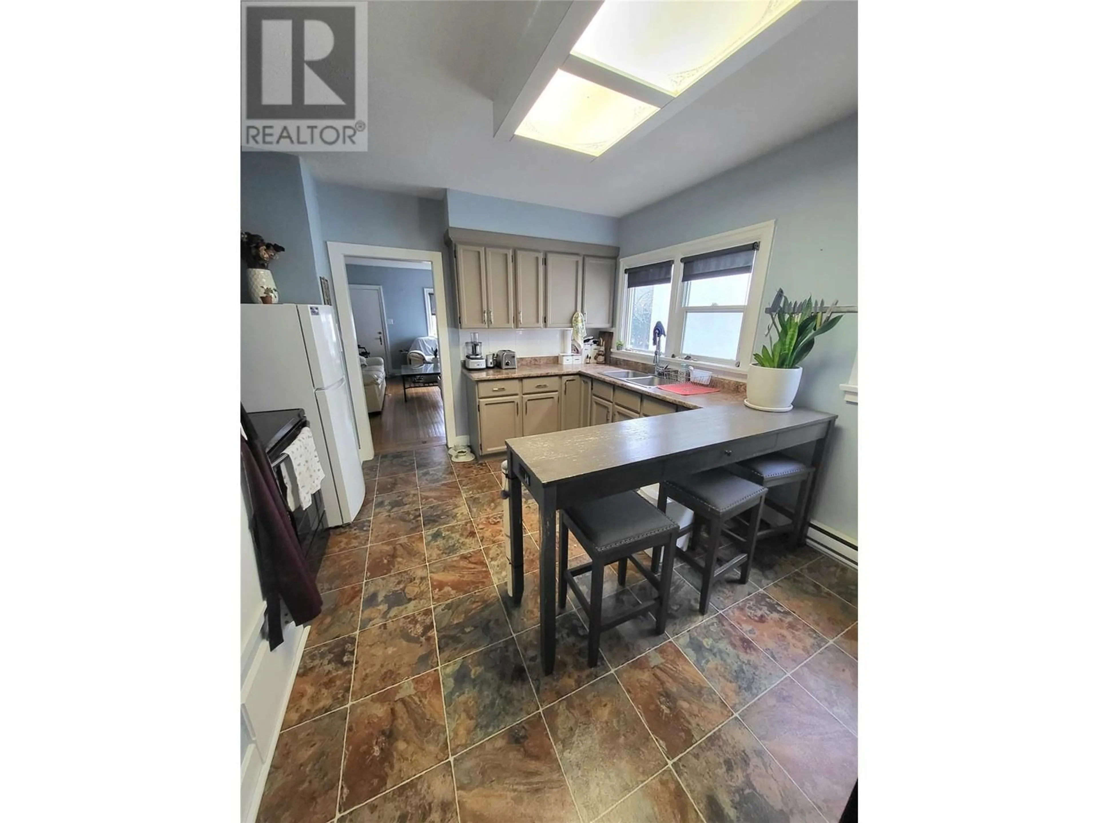 Open concept kitchen, ceramic/tile floor for 857 Main Street, Penticton British Columbia V2A5E3