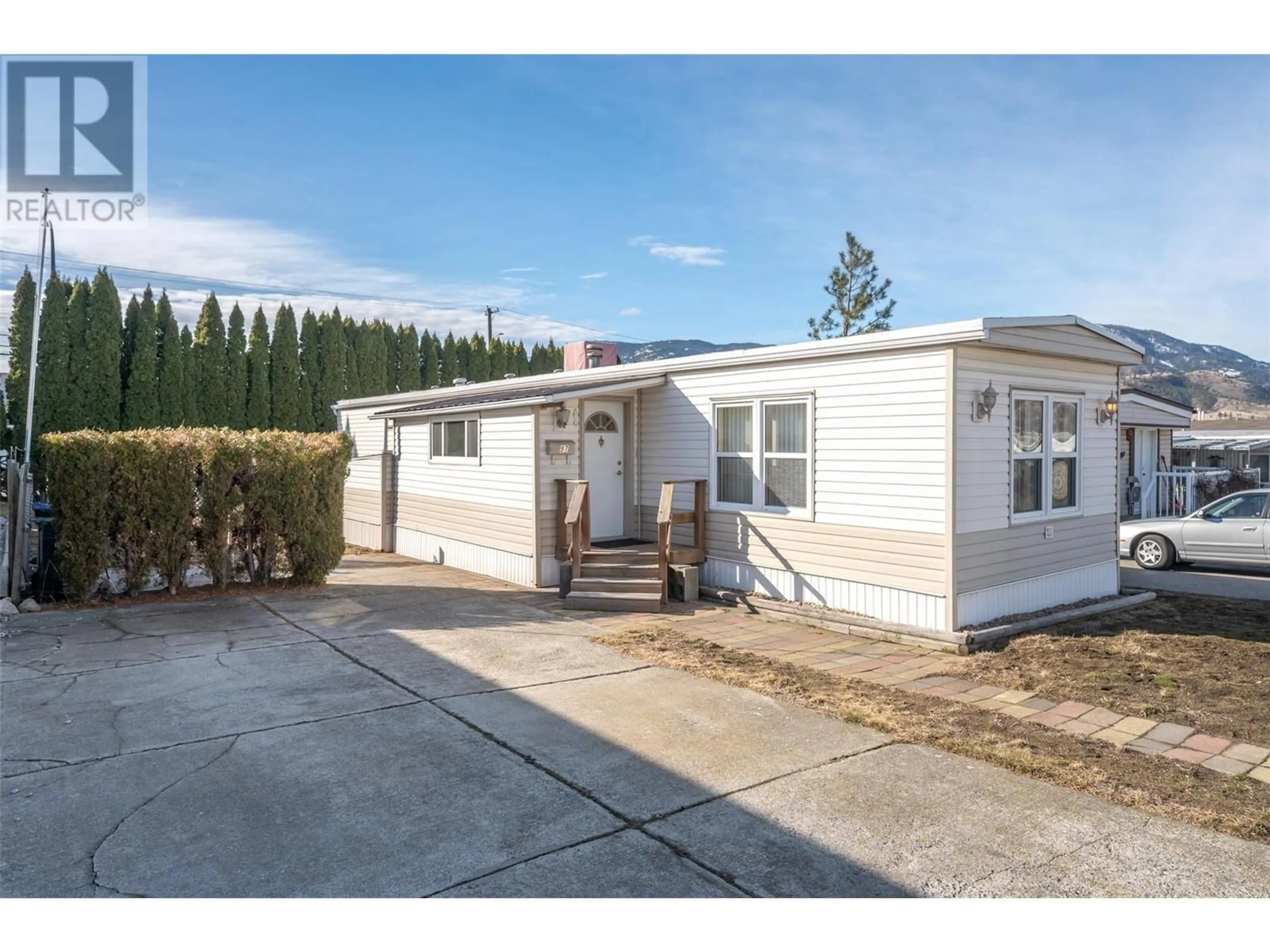 Home with vinyl exterior material, street for 97 - 98 OKANAGAN AVENUE EAST, Penticton British Columbia V2A3J5