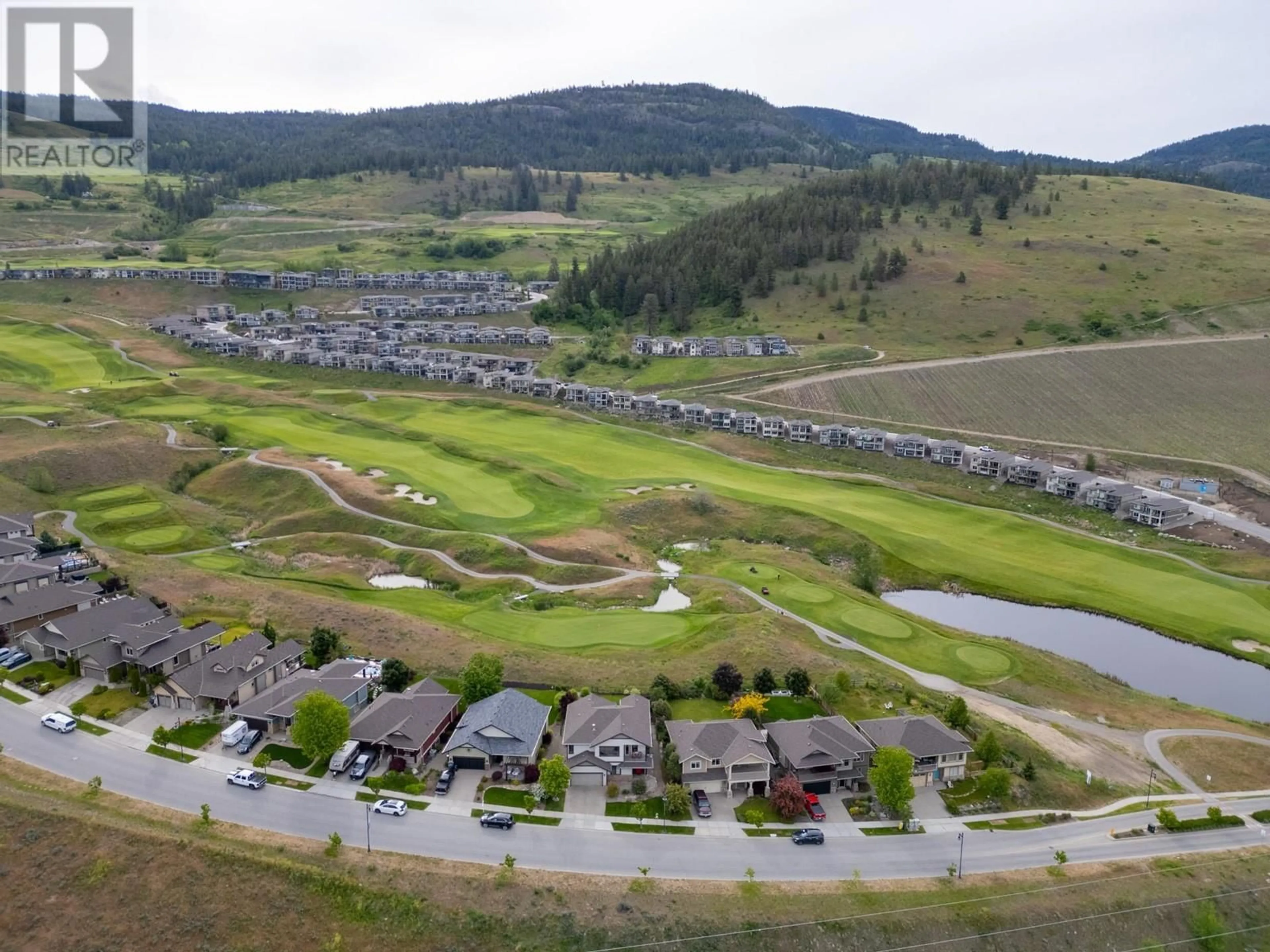 A pic from outside/outdoor area/front of a property/back of a property/a pic from drone, mountain view for 1585 TOWER RANCH BOULEVARD, Kelowna British Columbia V1P1P9