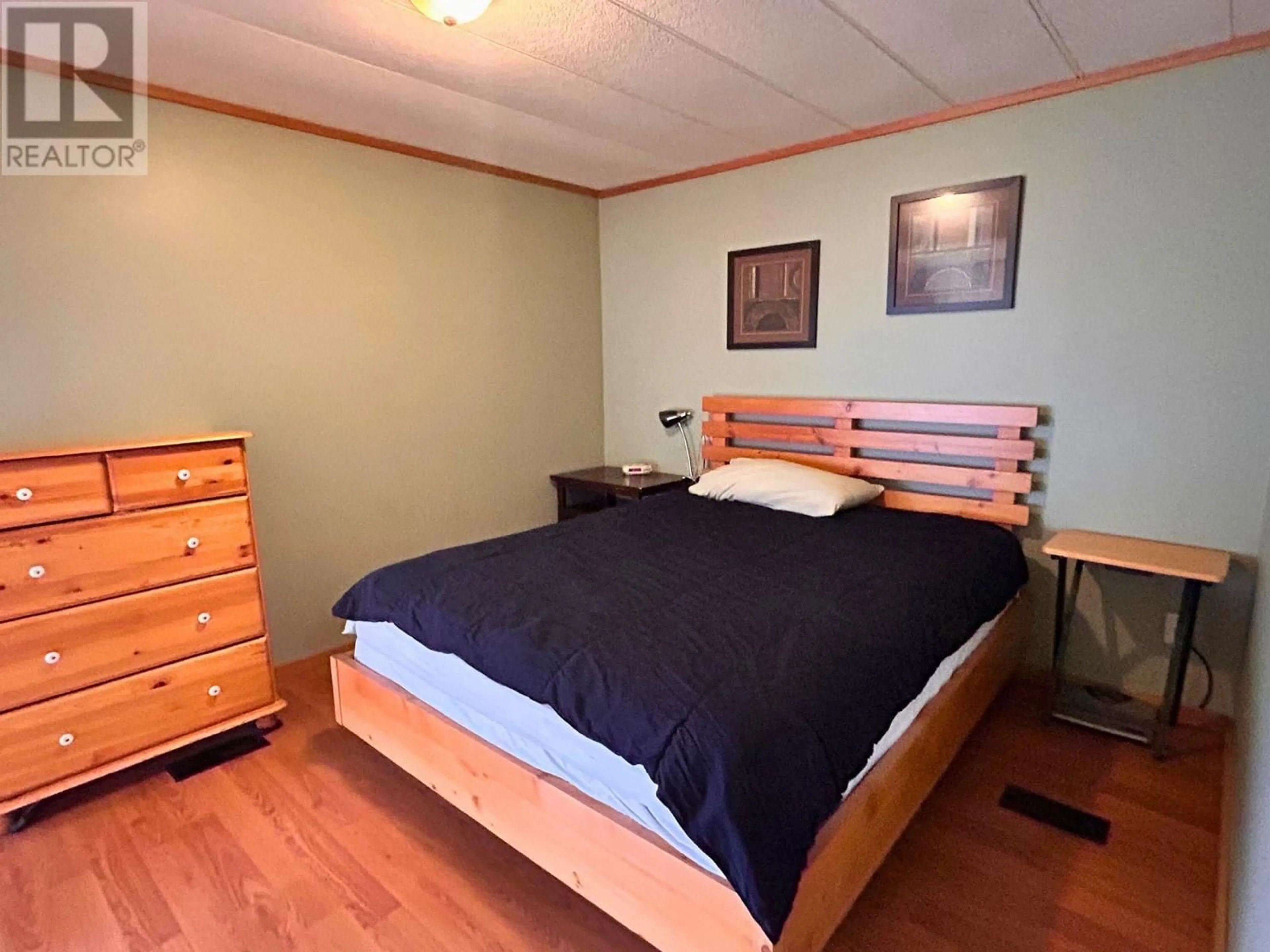 Bedroom with bed, wood/laminate floor for 6663 Highway 97 S Unit# 29, Peachland British Columbia V0H1X7