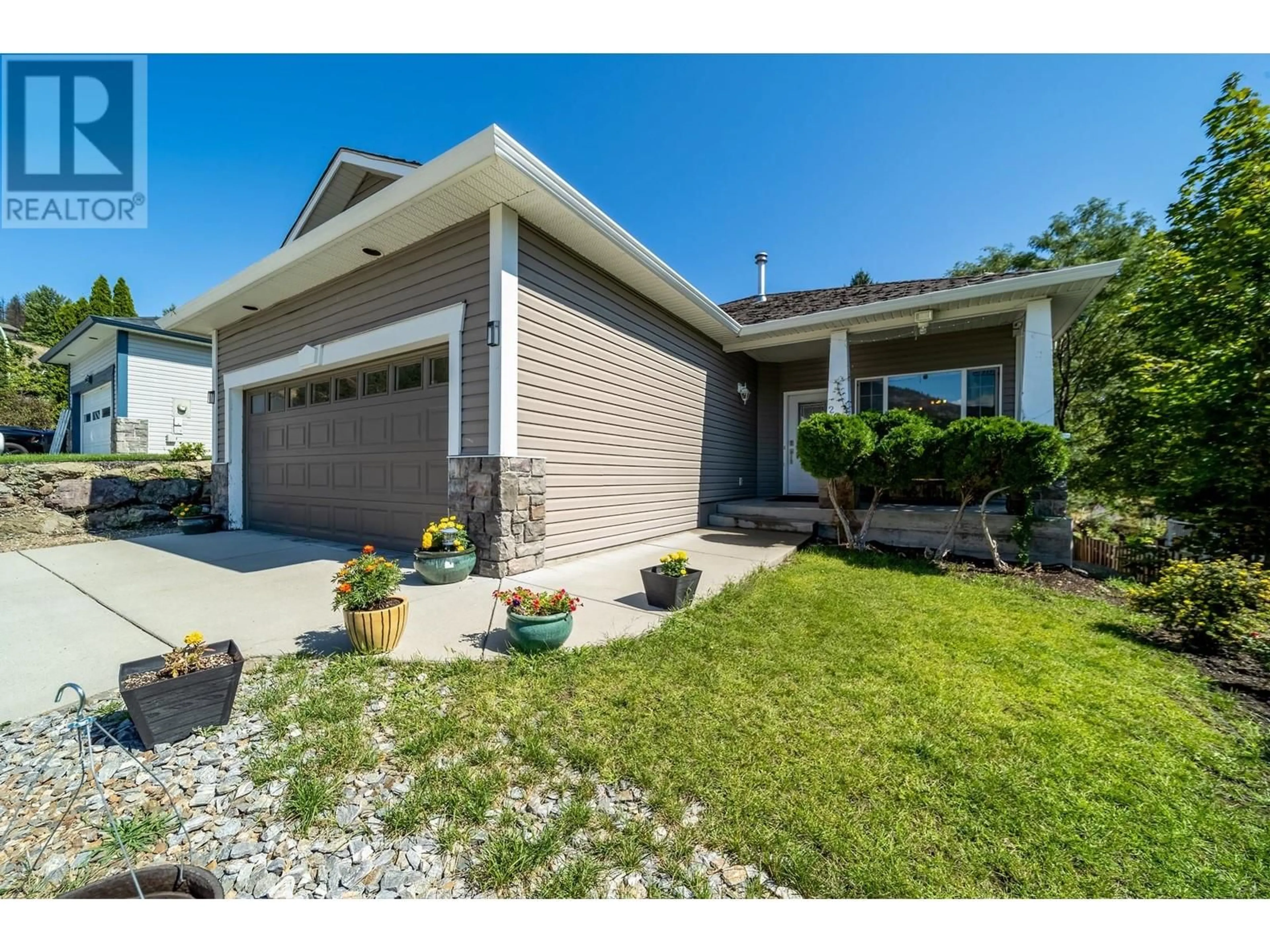 Home with brick exterior material, street for 2066 ROSEFIELD DRIVE, West Kelowna British Columbia V1Z3Y8