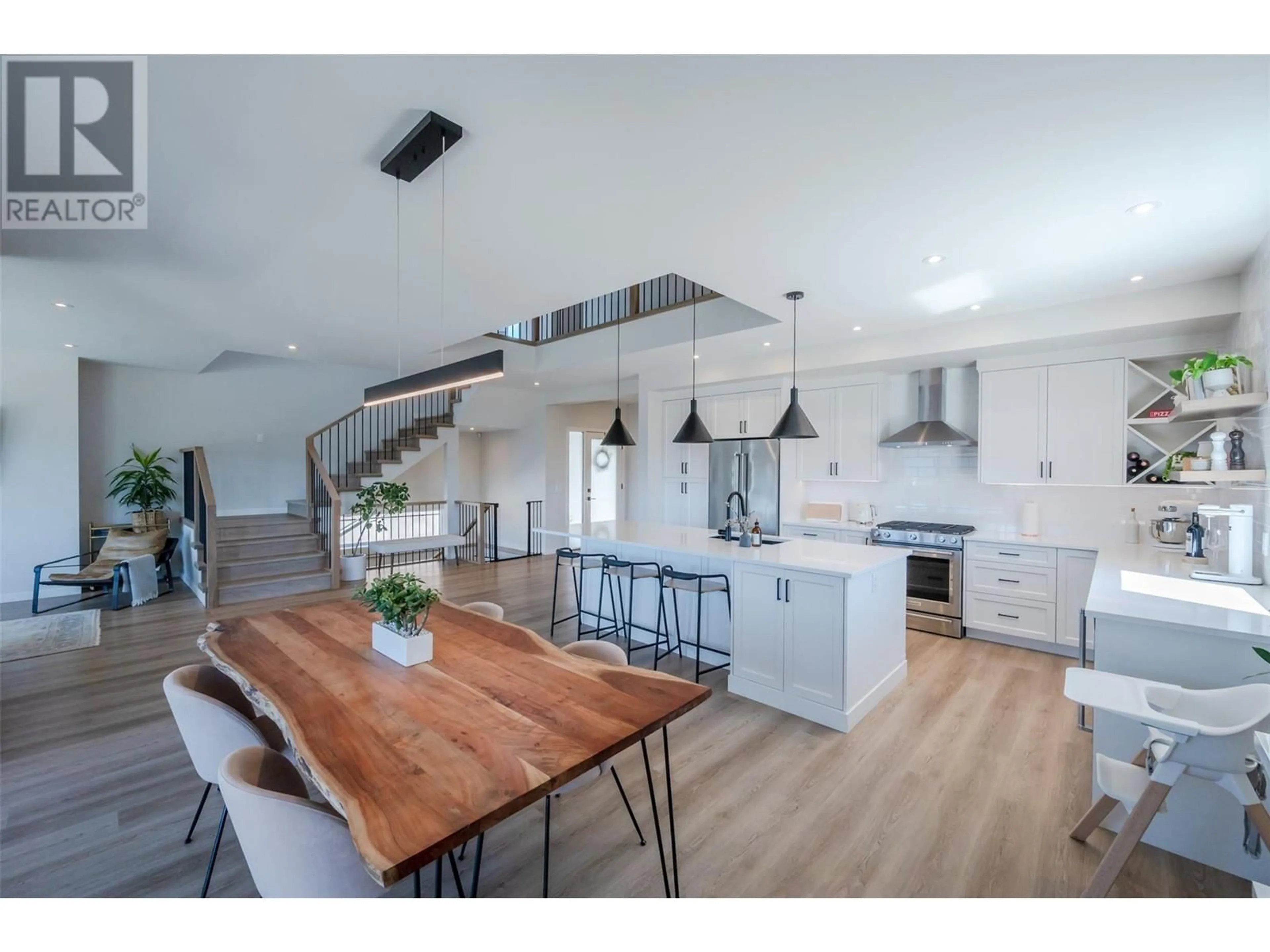 Open concept kitchen, wood/laminate floor for 174 Fawn Court, Penticton British Columbia V2A0C8