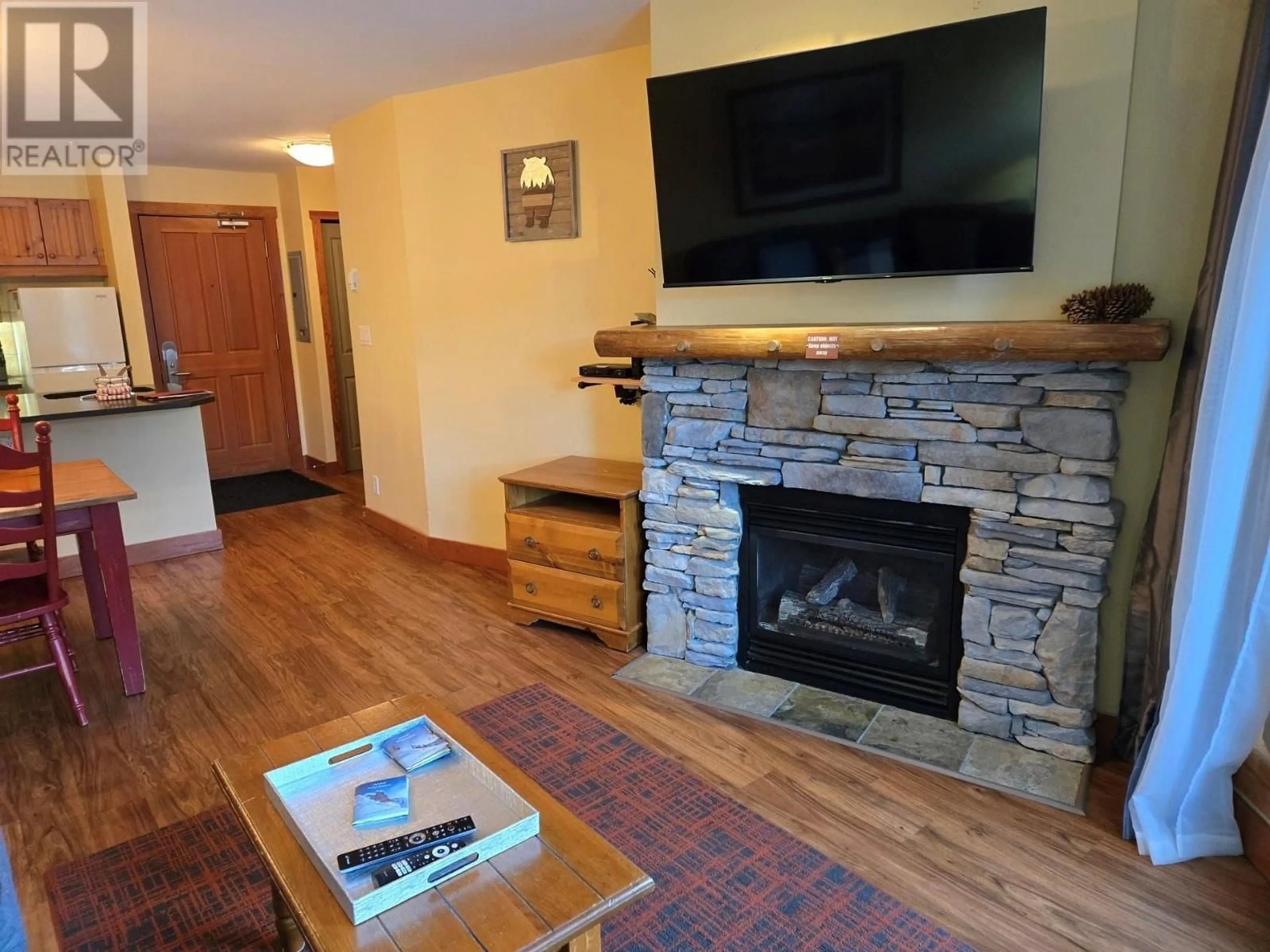 Living room with furniture, wood/laminate floor for 2080 Summit Drive Unit# 108, Panorama British Columbia V0A1T0