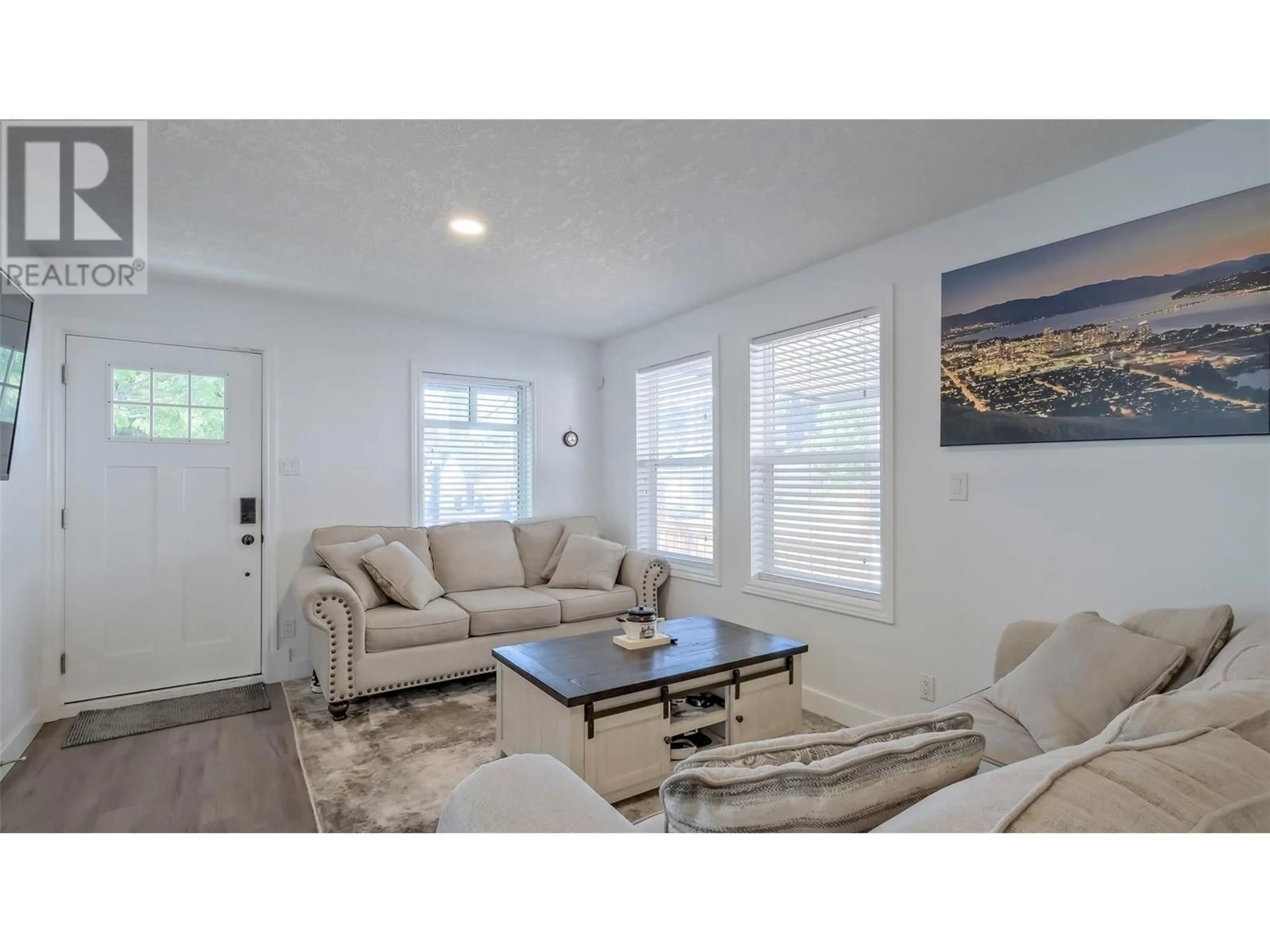 Living room with furniture, wood/laminate floor for 726 CORONATION AVENUE, Kelowna British Columbia V1Y7A3