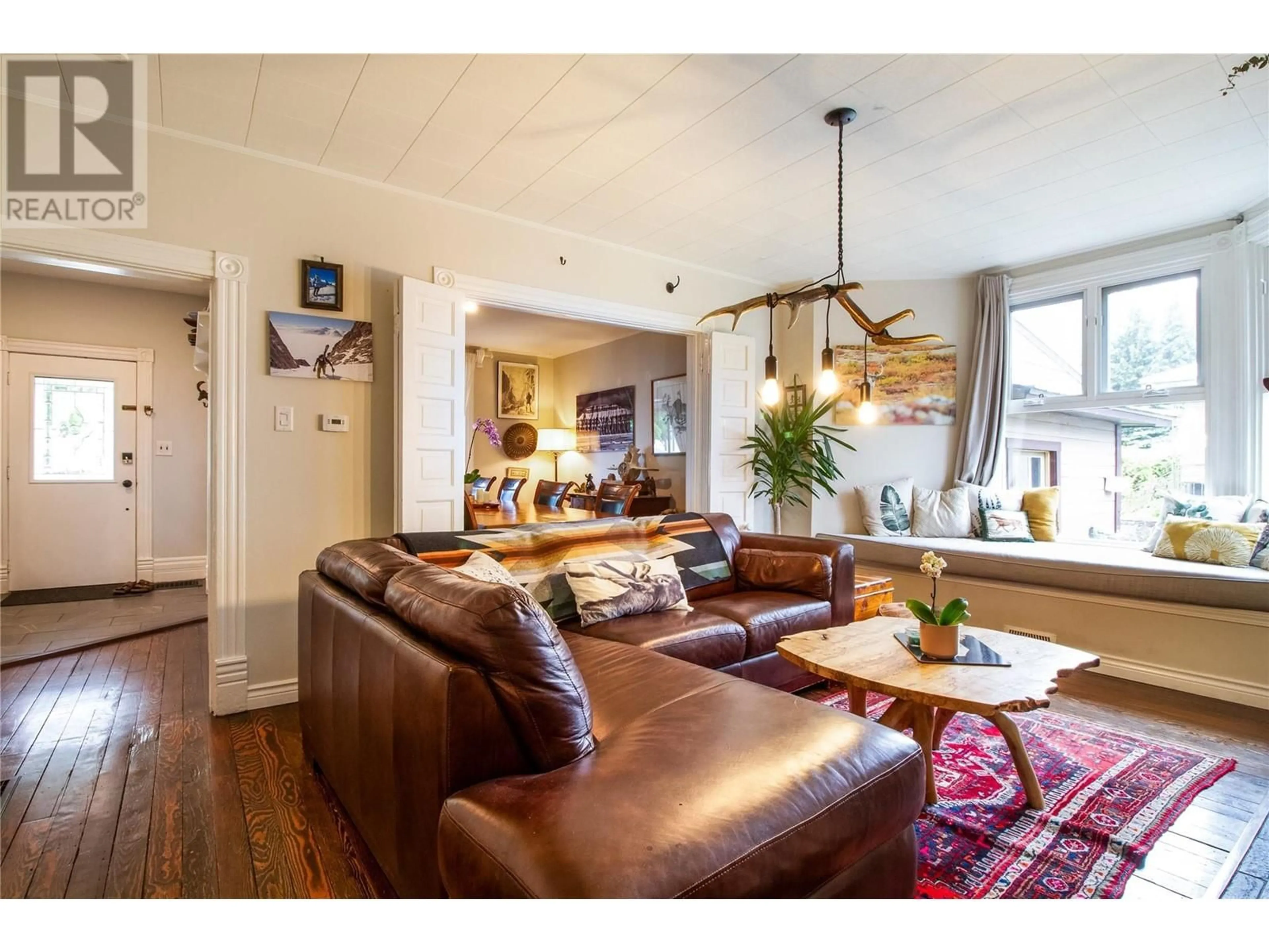 Living room with furniture, wood/laminate floor for 107 Third Street E, Revelstoke British Columbia V0E2S0