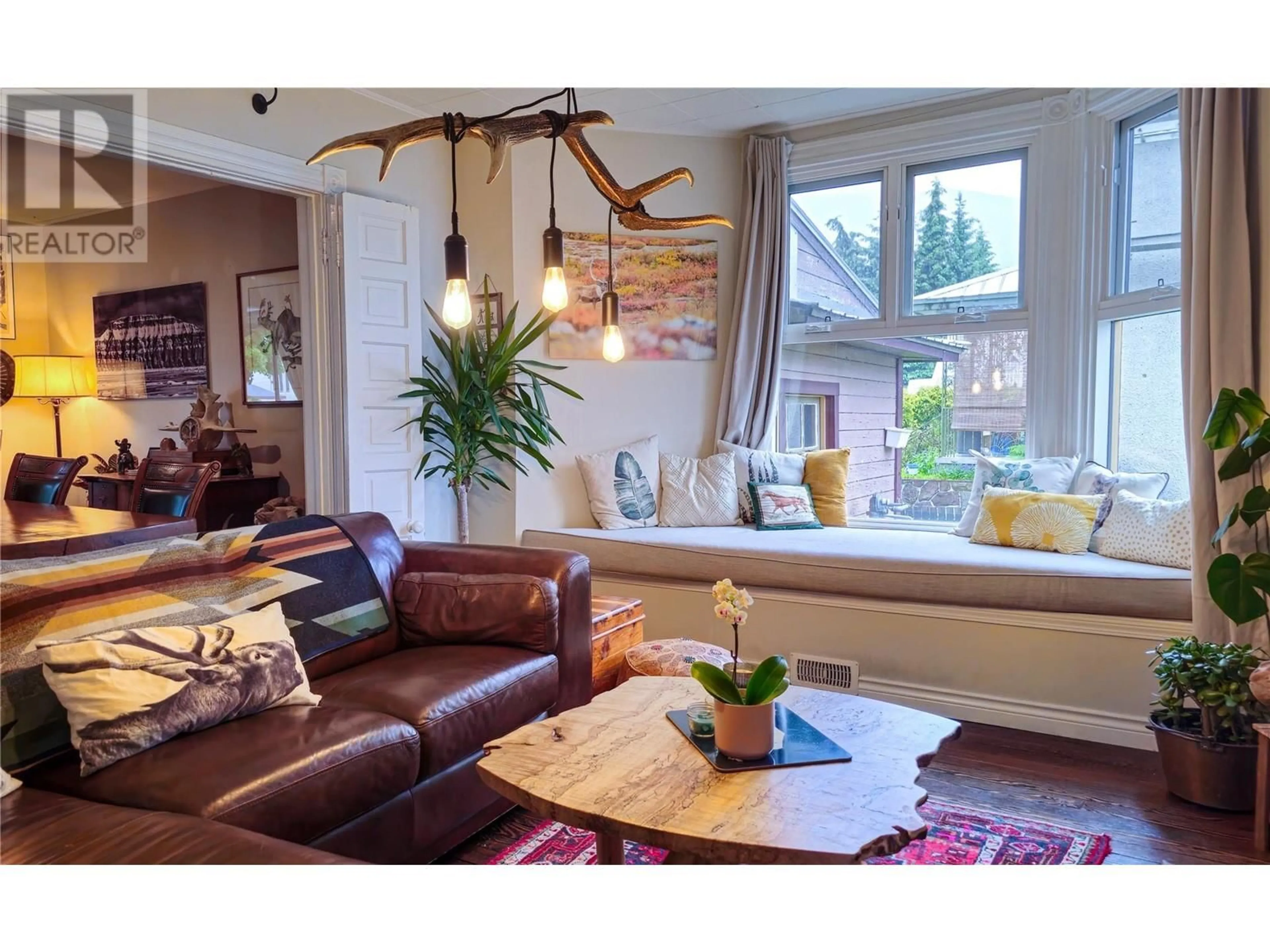 Living room with furniture, wood/laminate floor for 107 Third Street E, Revelstoke British Columbia V0E2S0