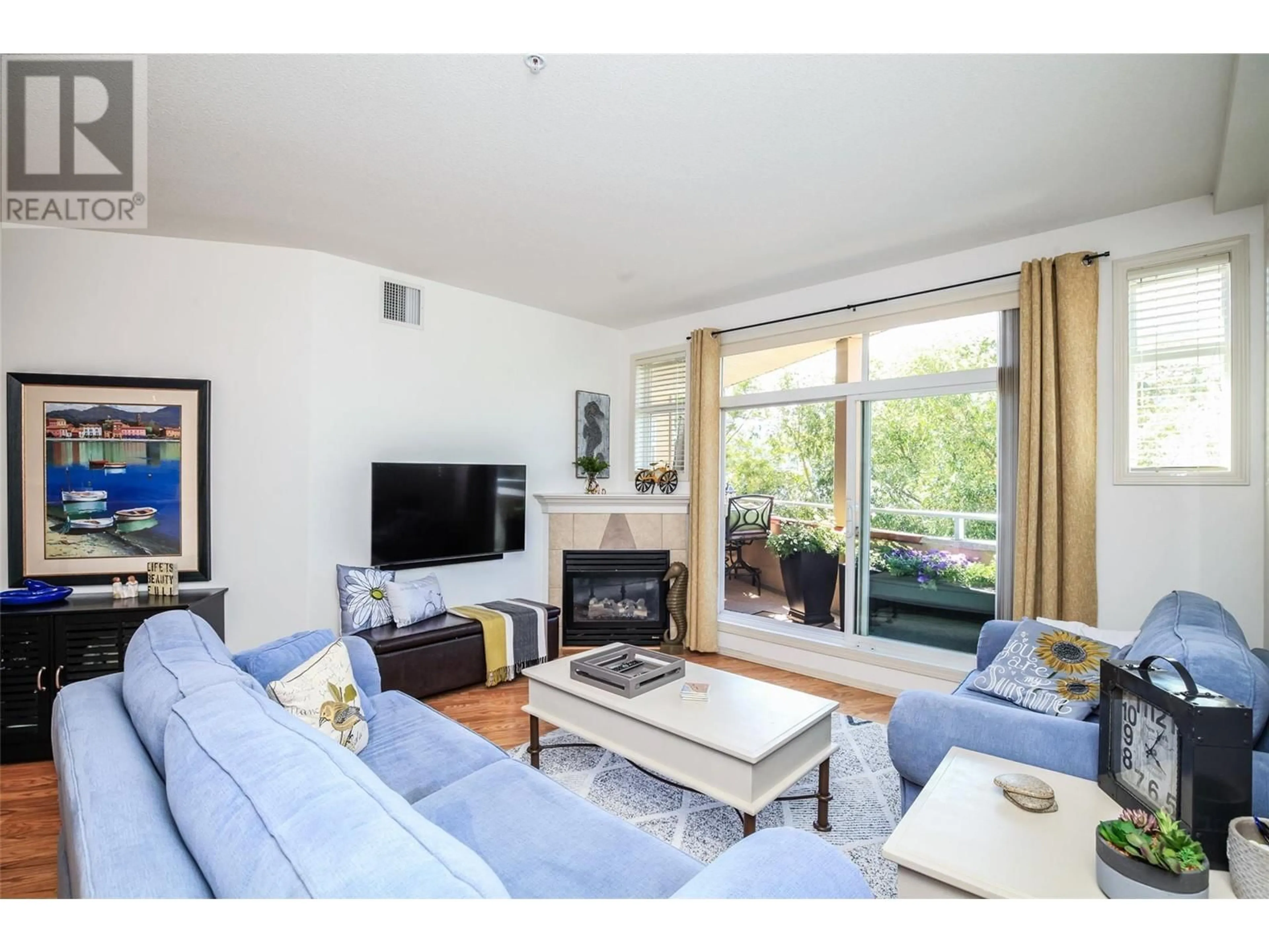 Living room with furniture, wood/laminate floor for 312 - 1088 SUNSET DRIVE, Kelowna British Columbia V1Y9W1