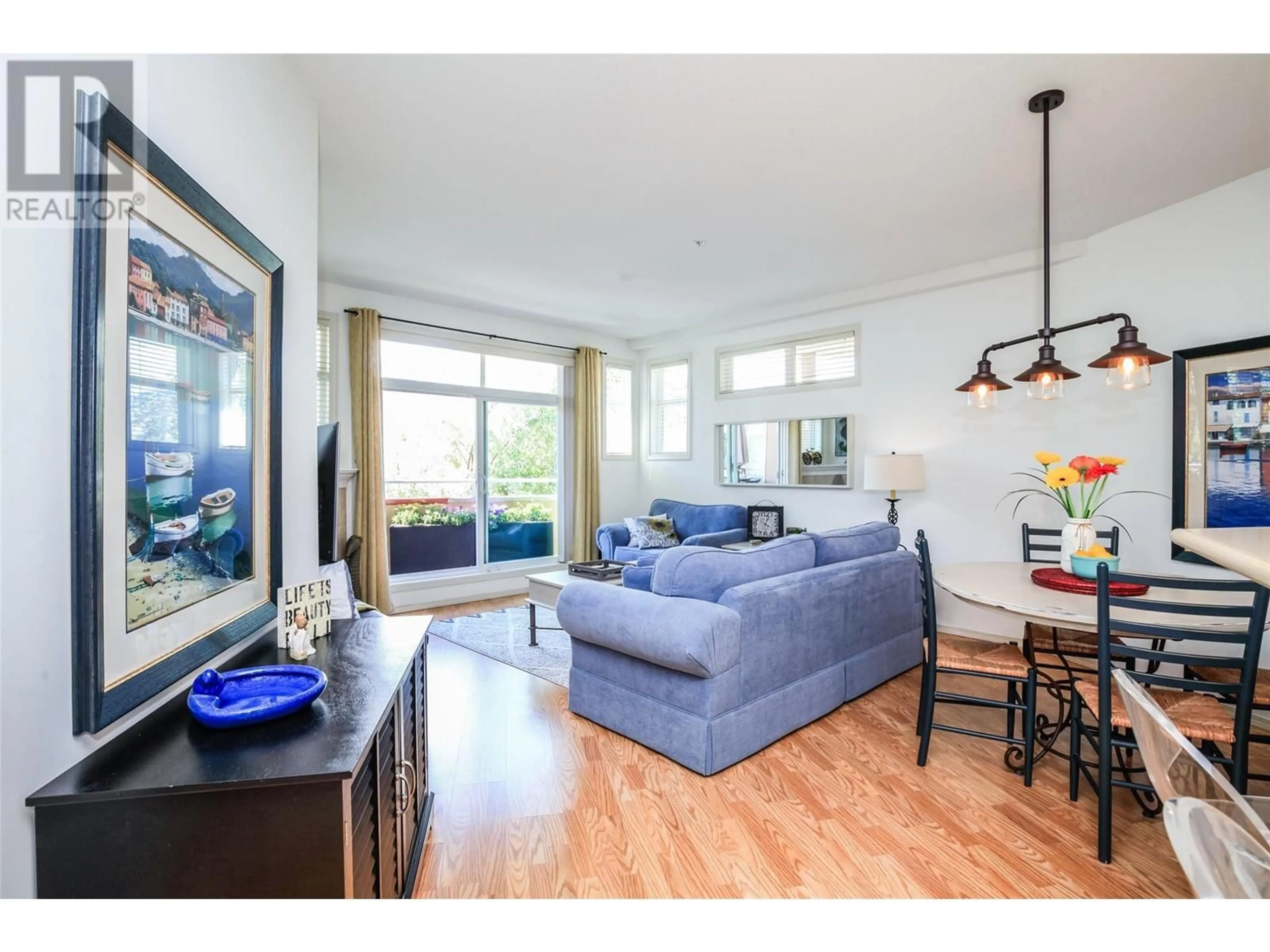 Living room with furniture, wood/laminate floor for 312 - 1088 SUNSET DRIVE, Kelowna British Columbia V1Y9W1