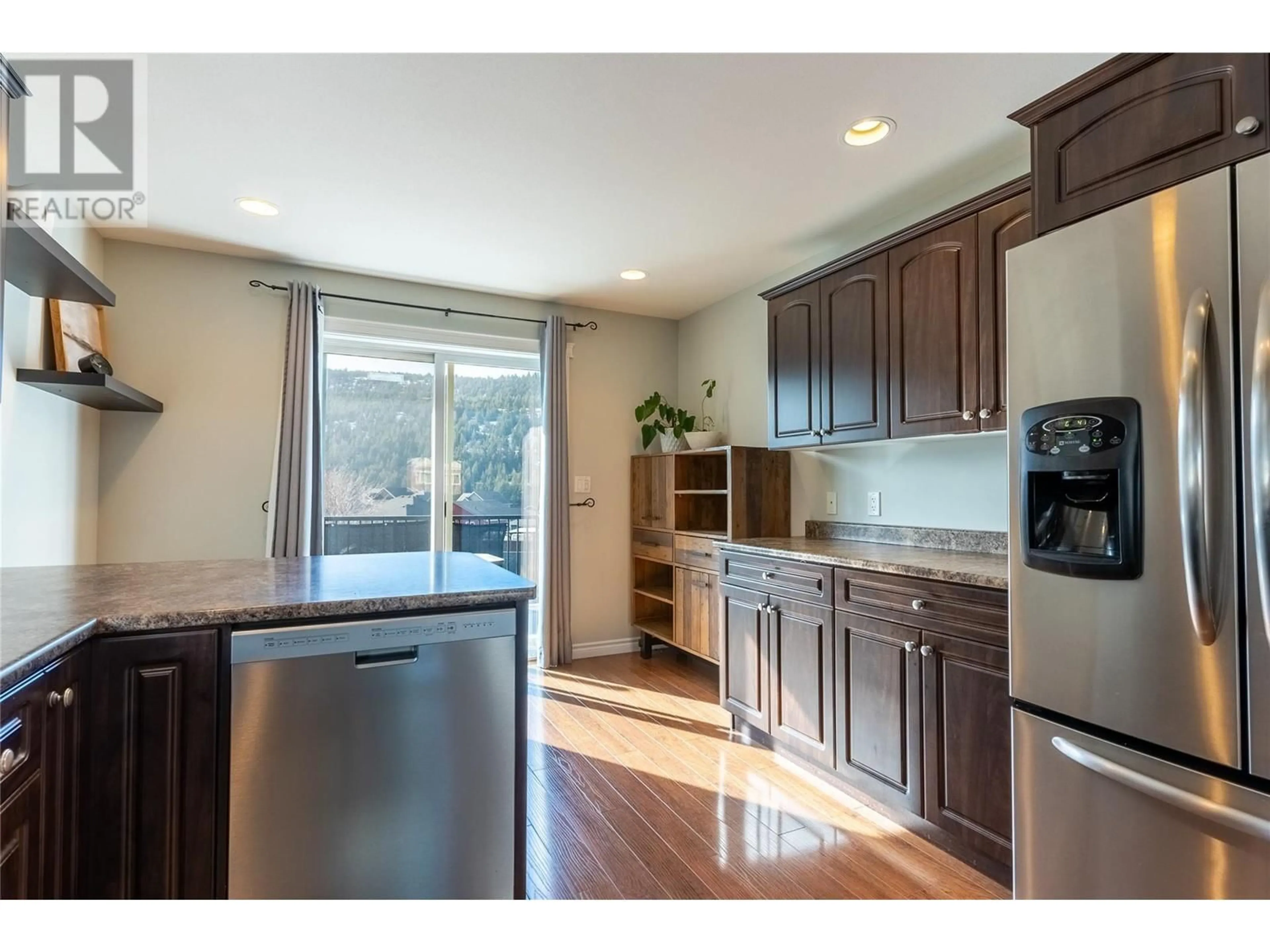 Open concept kitchen, wood/laminate floor for 1808 PRIMROSE CRESCENT, Kamloops British Columbia V1S0A6
