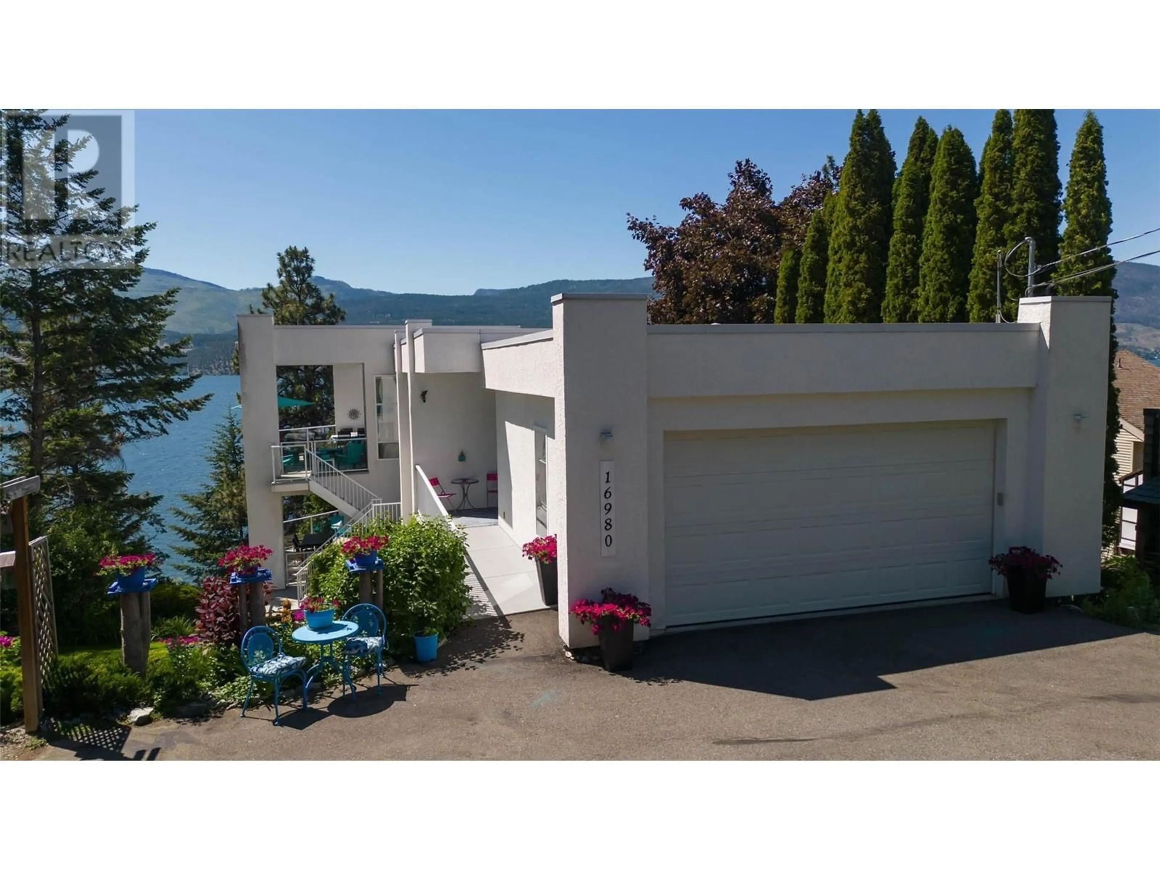 A pic from outside/outdoor area/front of a property/back of a property/a pic from drone, water/lake/river/ocean view for 16980 Coral Beach Road, Lake Country British Columbia V4V1B9