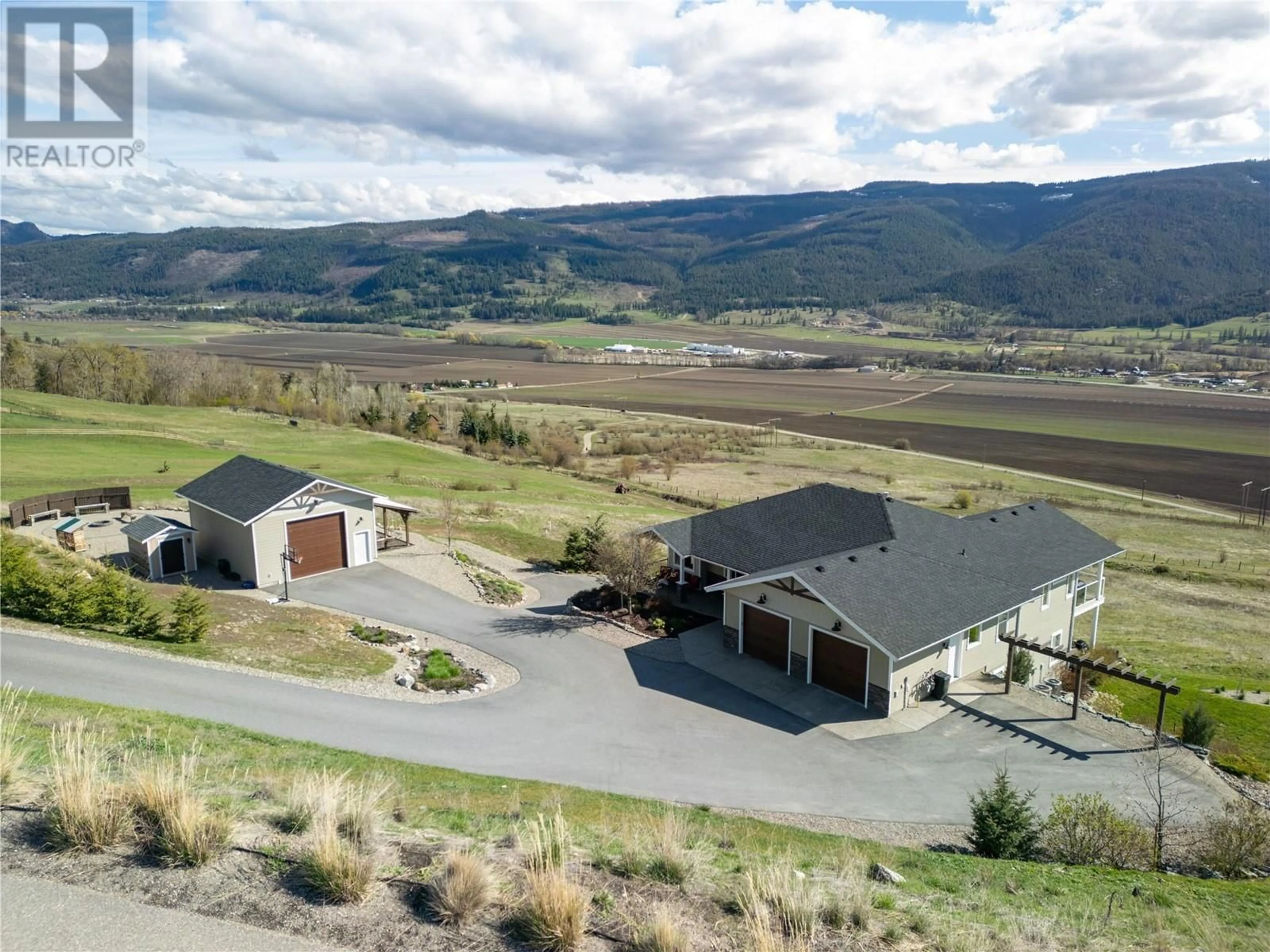 A pic from outside/outdoor area/front of a property/back of a property/a pic from drone, mountain view for 98 RANCHLAND PLACE, Coldstream British Columbia V1B4C9