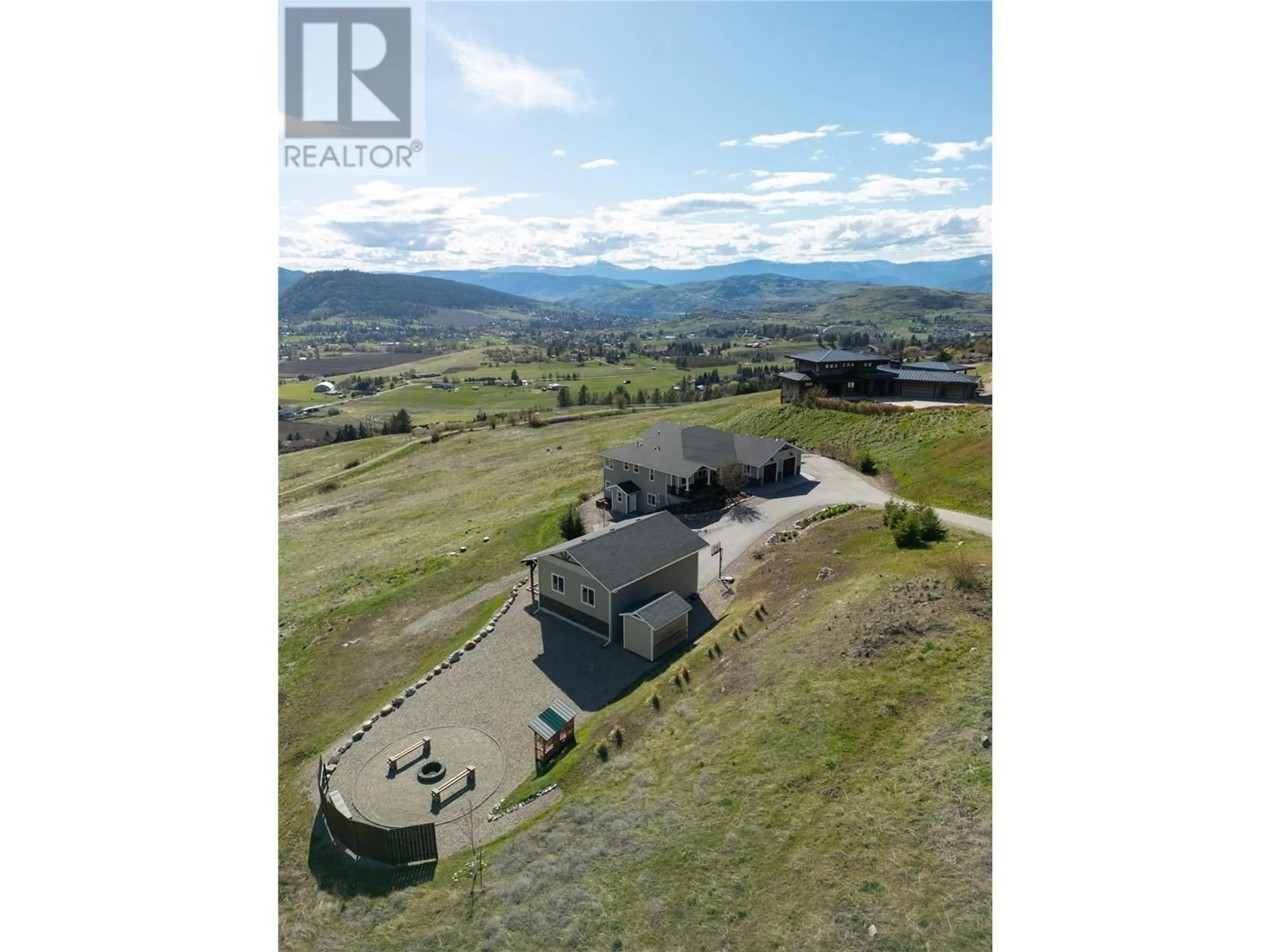 A pic from outside/outdoor area/front of a property/back of a property/a pic from drone, mountain view for 98 Ranchland Place, Coldstream British Columbia V1B4C9