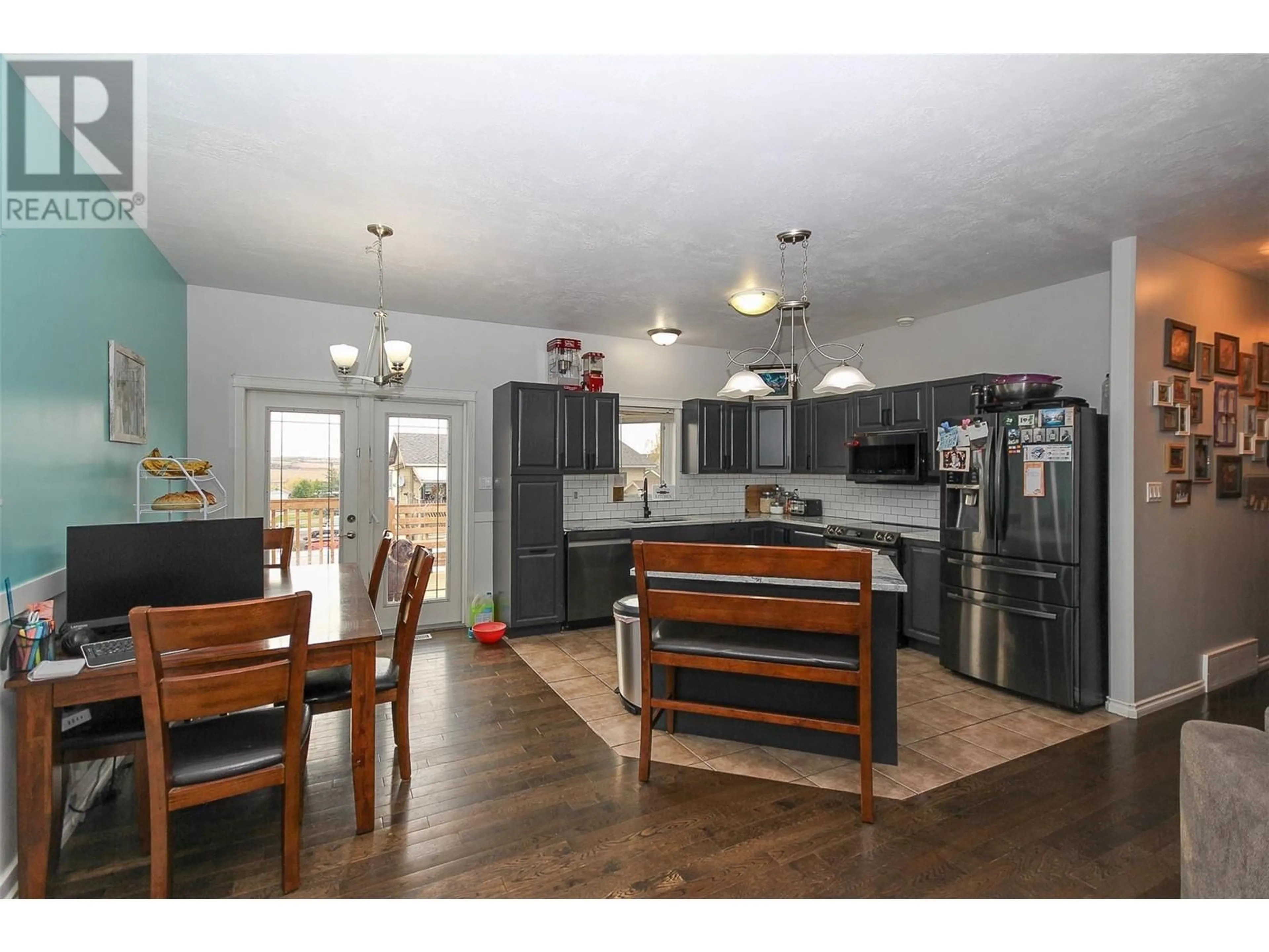 Open concept kitchen, wood/laminate floor for 8709 19A Street, Dawson Creek British Columbia V1G0A7