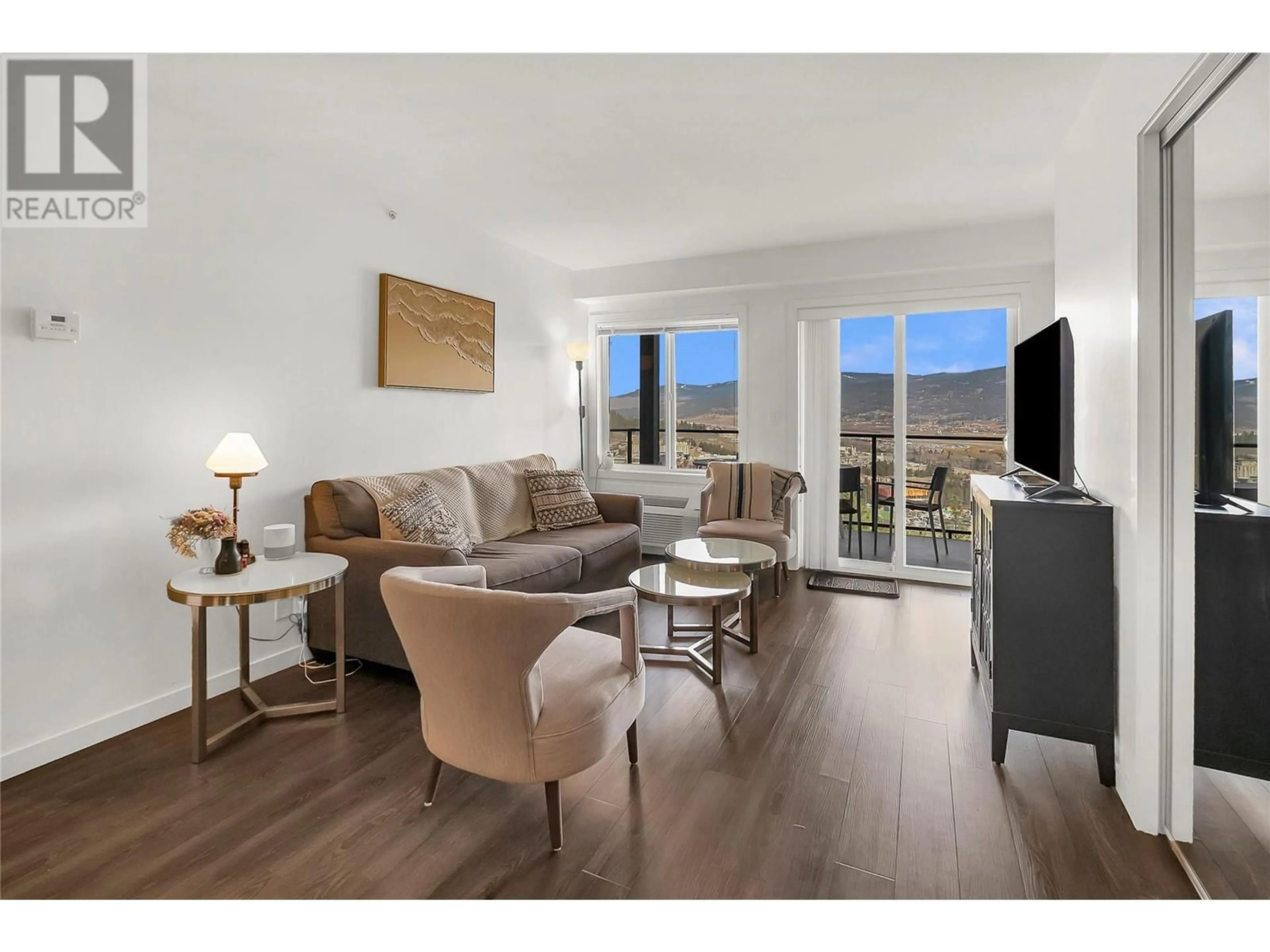 Living room with furniture, wood/laminate floor for PH2 - 883 ACADEMY WAY, Kelowna British Columbia V1V0A5
