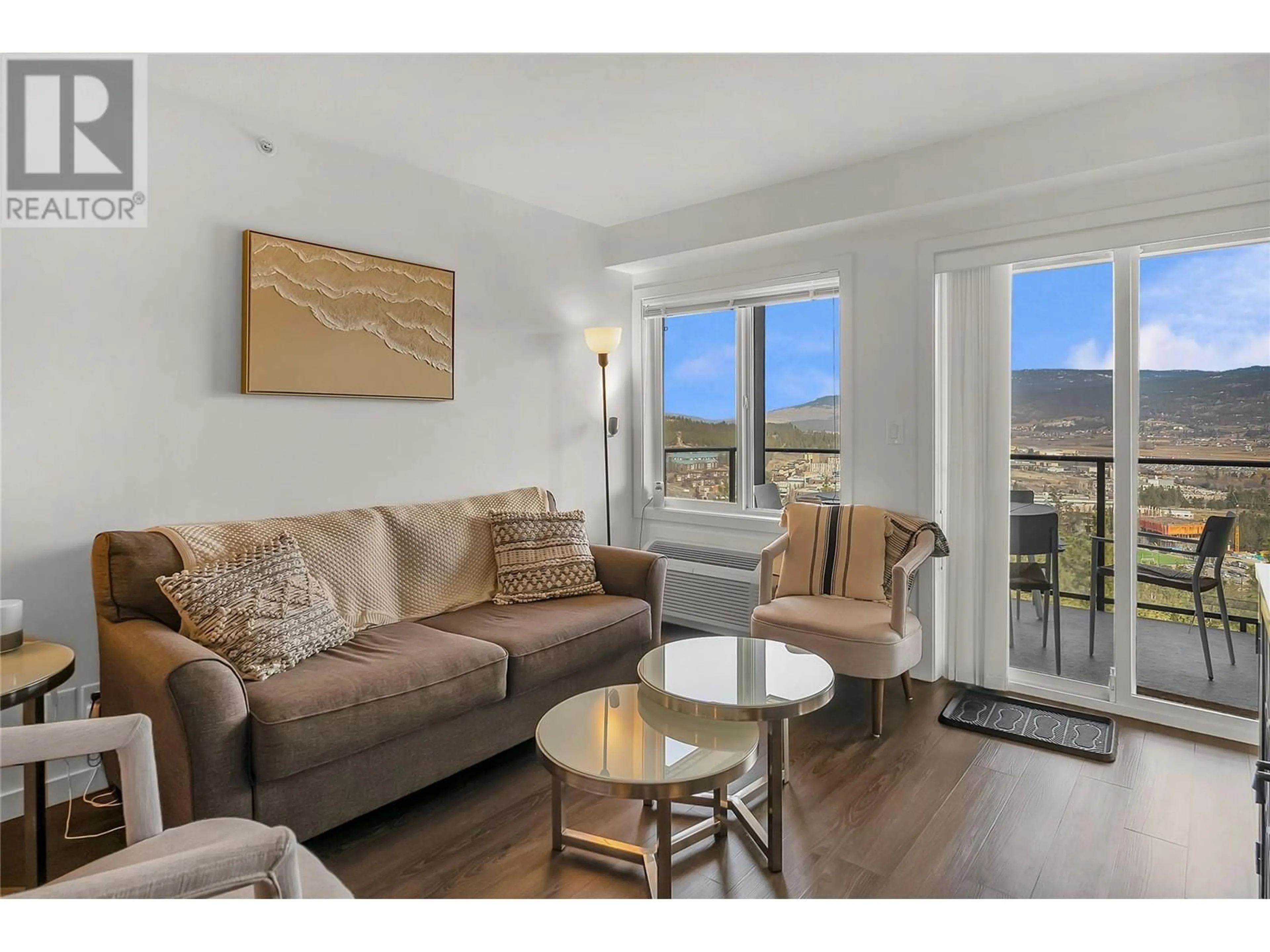 Living room with furniture, wood/laminate floor for PH2 - 883 ACADEMY WAY, Kelowna British Columbia V1V0A5