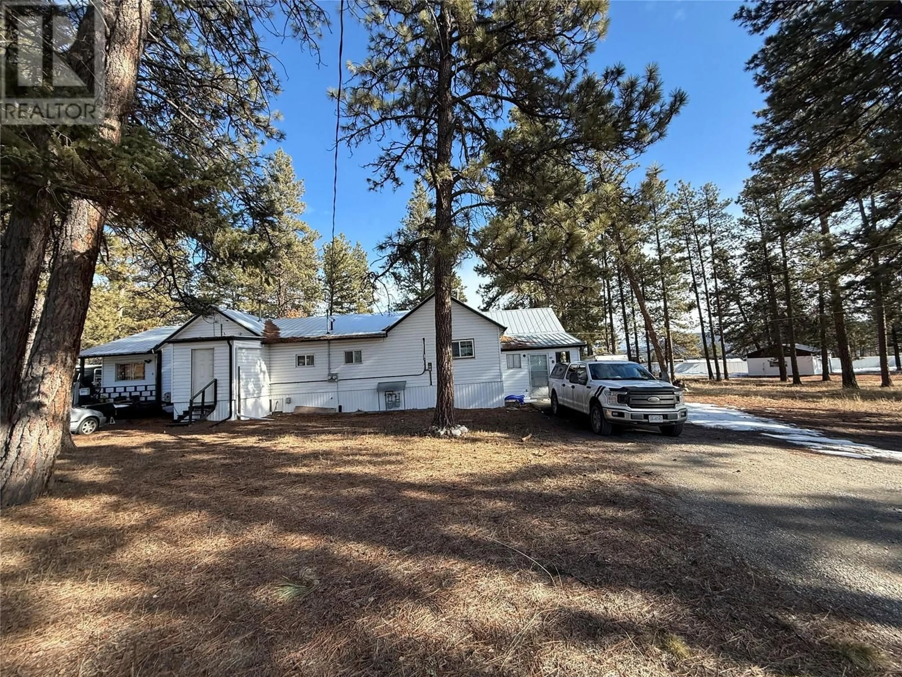 A pic from outside/outdoor area/front of a property/back of a property/a pic from drone, forest/trees view for 824 4th Street NW, Cranbrook British Columbia V1C4A4