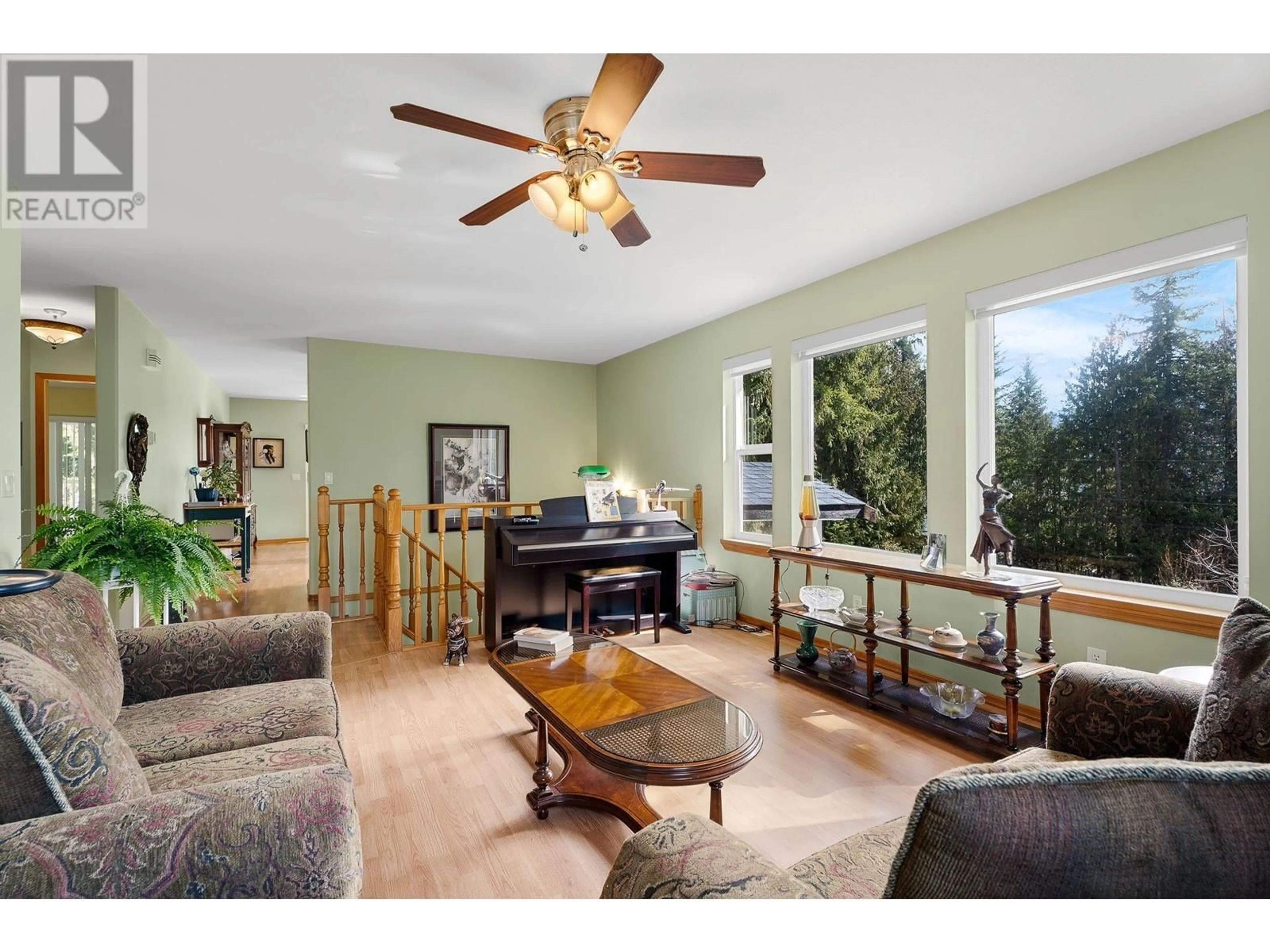 Living room with furniture, wood/laminate floor for 7451 ESTATE DRIVE, Anglemont British Columbia V0E1M8