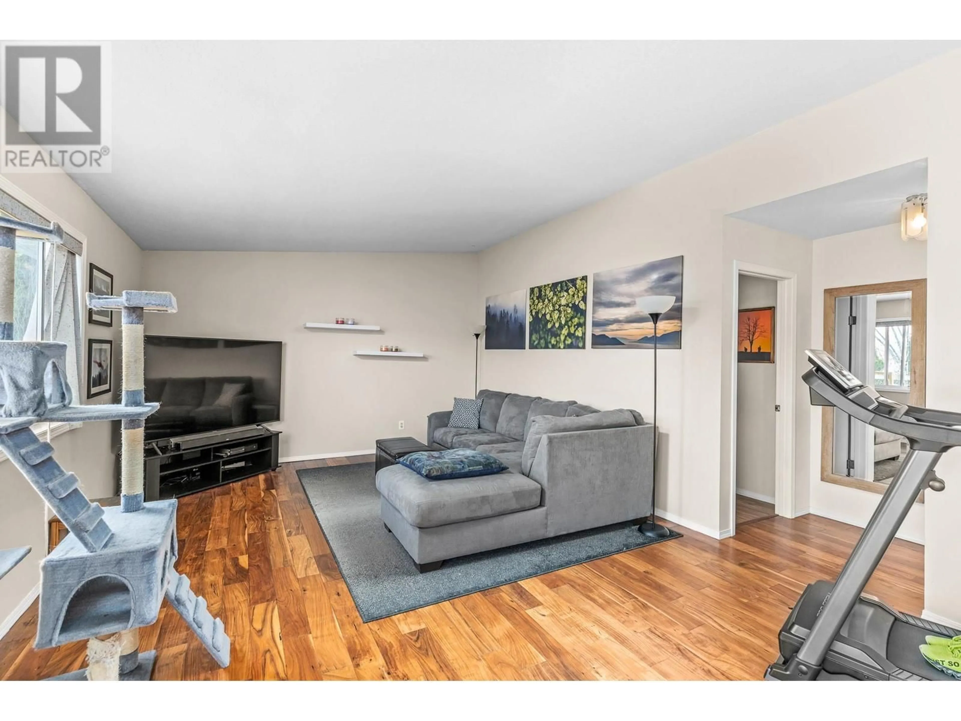 Living room with furniture, wood/laminate floor for 2125 SHAMROCK DRIVE, West Kelowna British Columbia V4T1T9