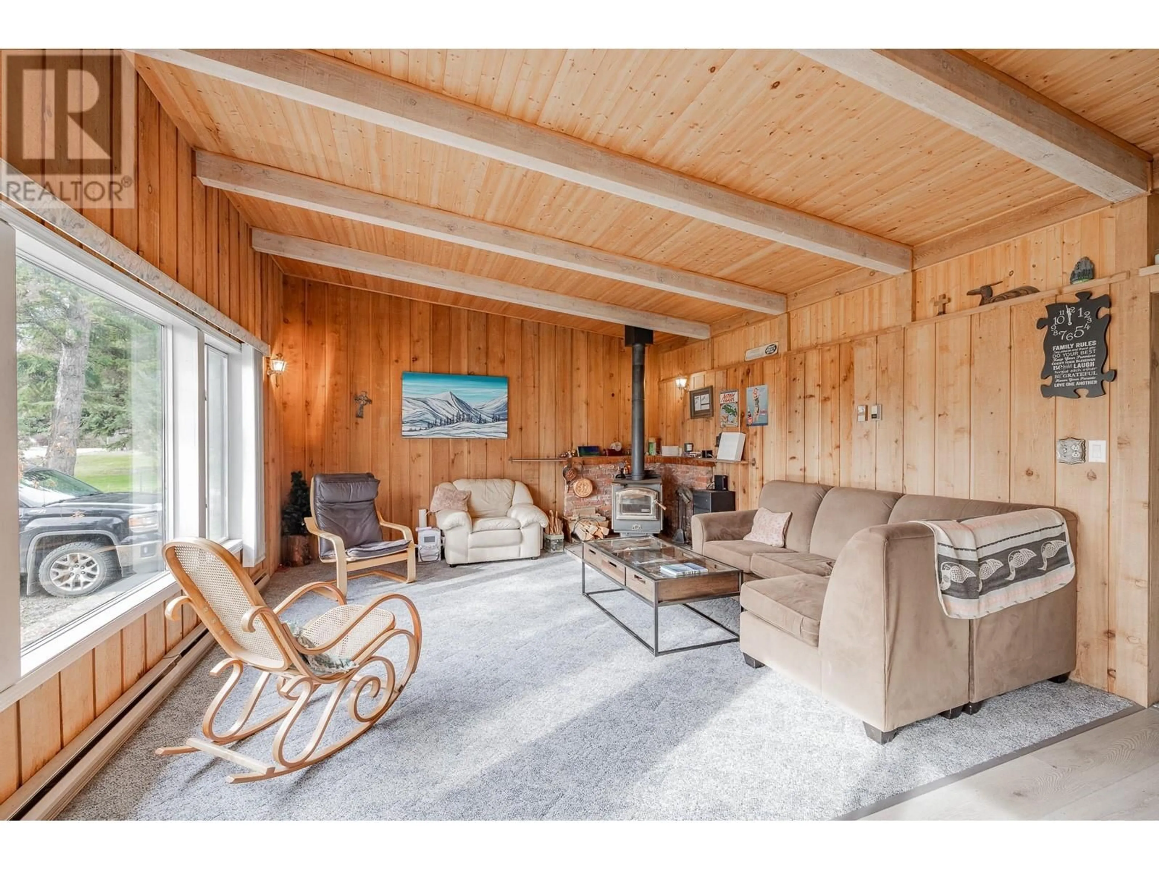 Living room with furniture, wood/laminate floor for 4661 Columere Road, Fairmont Hot Springs British Columbia V0B1L2