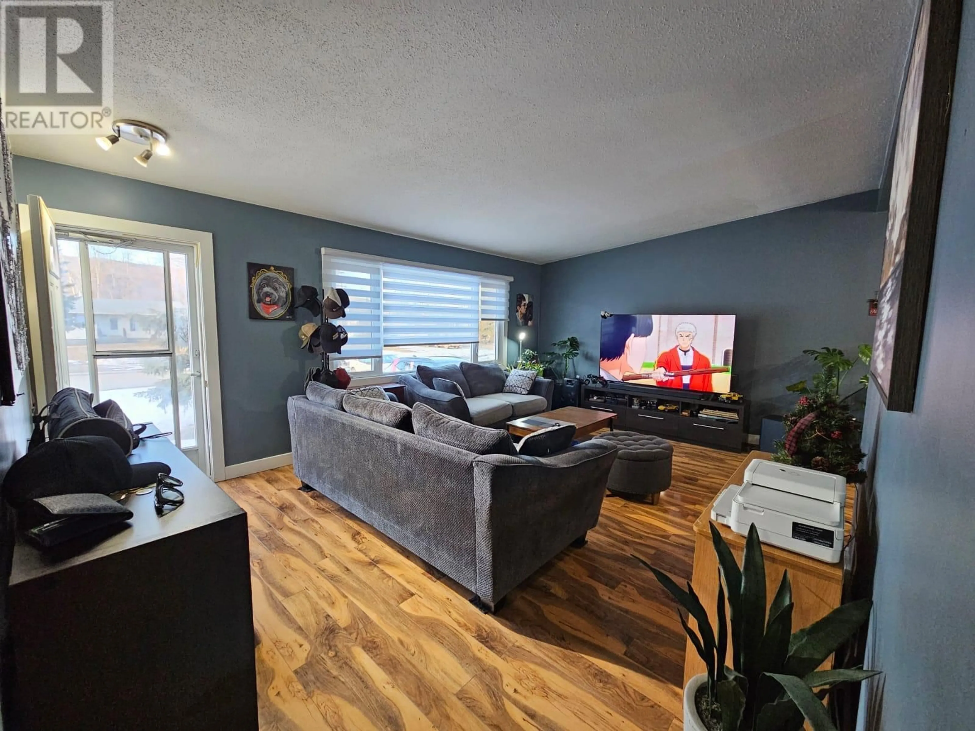 Living room with furniture, wood/laminate floor for 4529 49 Avenue, Chetwynd British Columbia V0C1J0