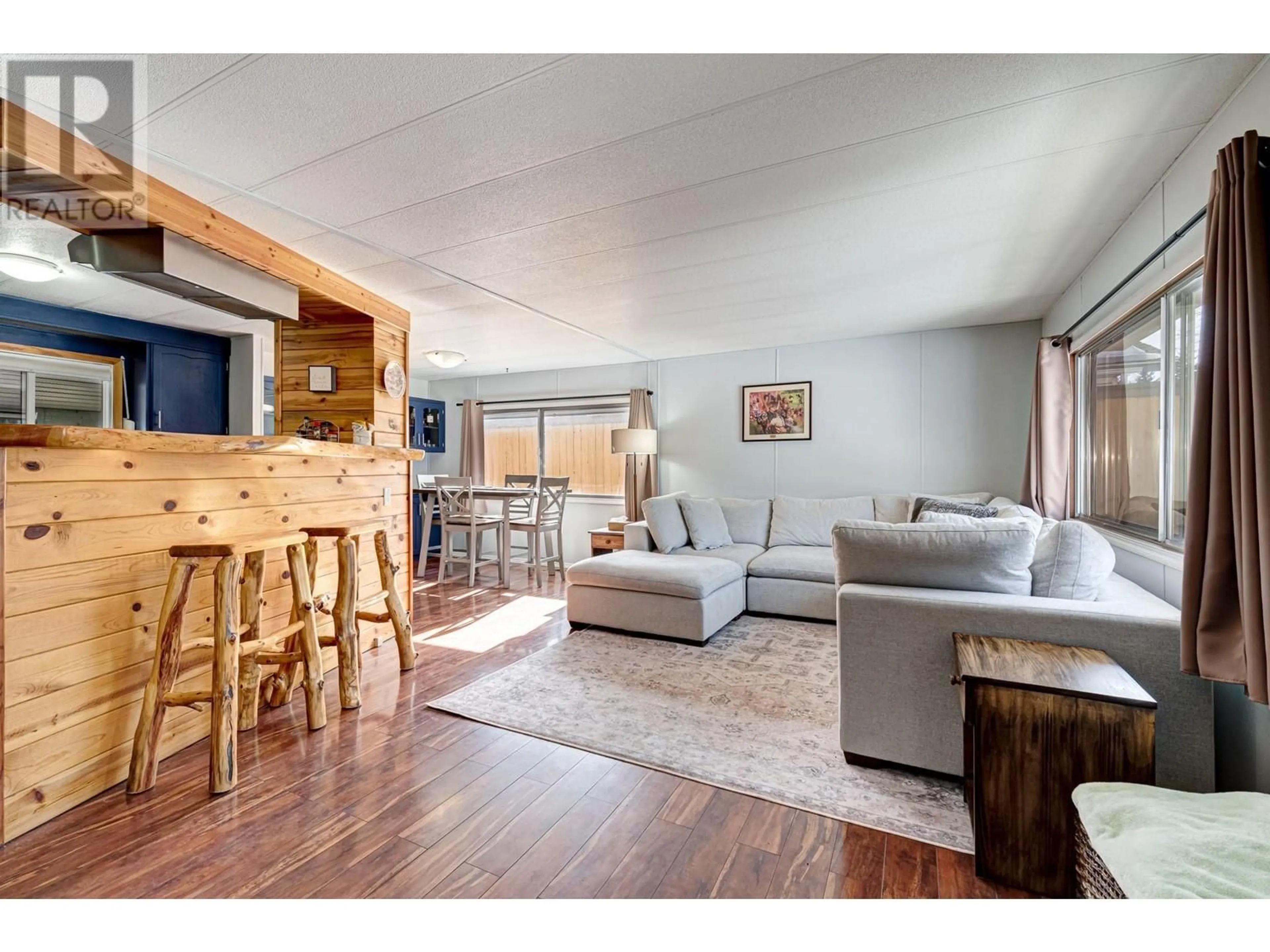 Living room with furniture, wood/laminate floor for 1622 11 Avenue, Fernie British Columbia V0B1M0