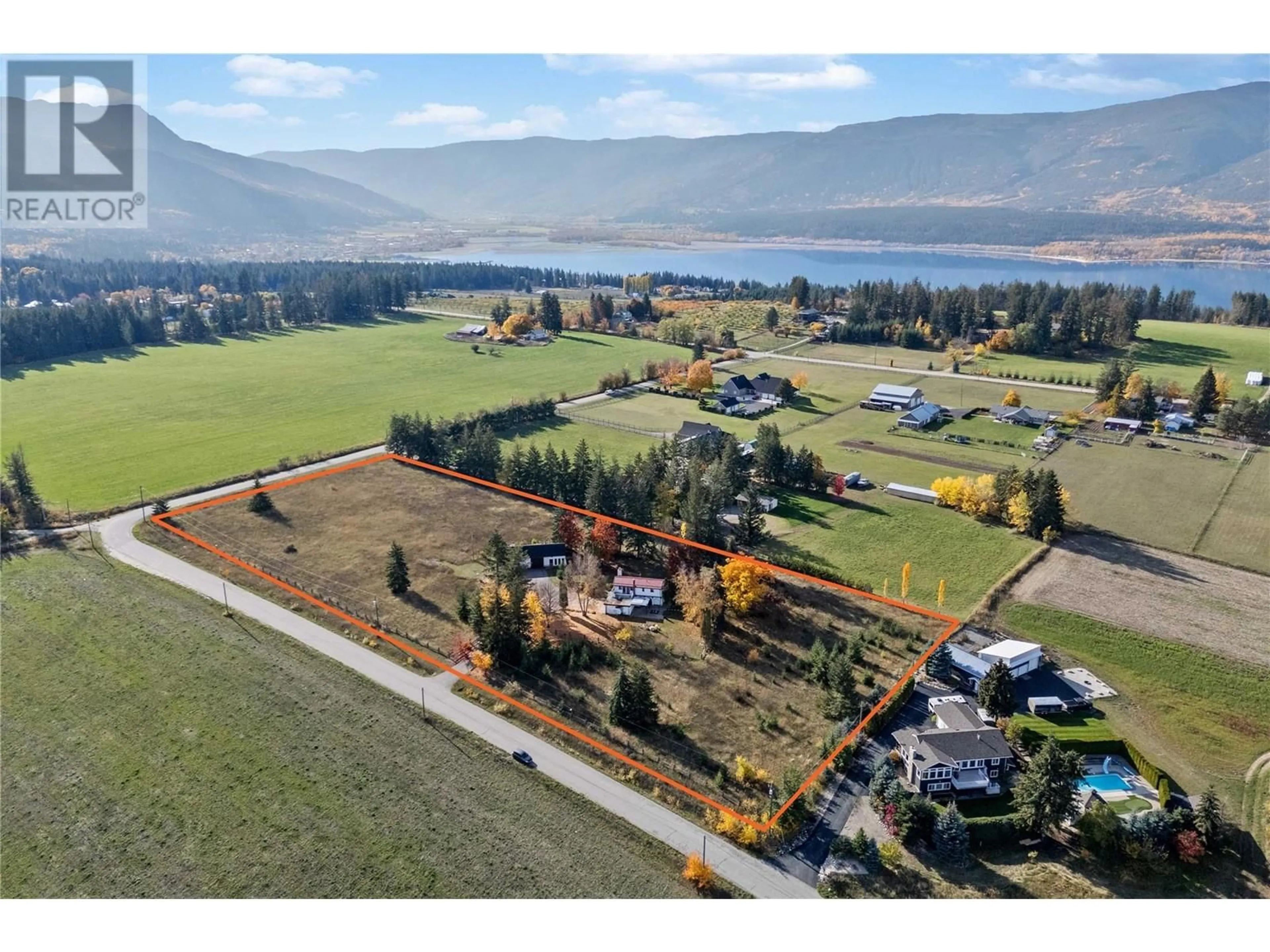 A pic from outside/outdoor area/front of a property/back of a property/a pic from drone, water/lake/river/ocean view for 5261 35 Street NE, Salmon Arm British Columbia V1E2B3