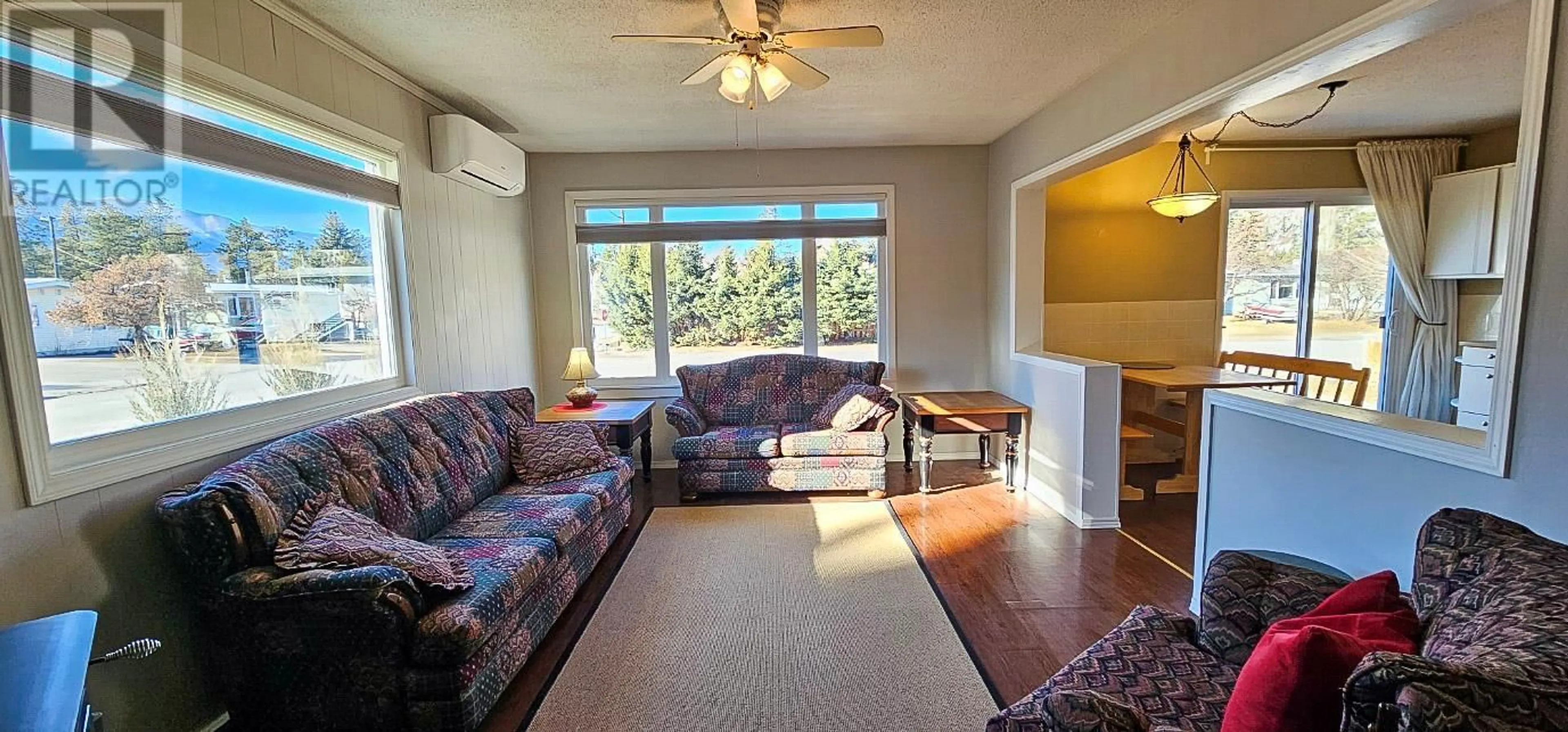 Living room with furniture, wood/laminate floor for 8788 Tamarack Street, Canal Flats British Columbia V0B1B0