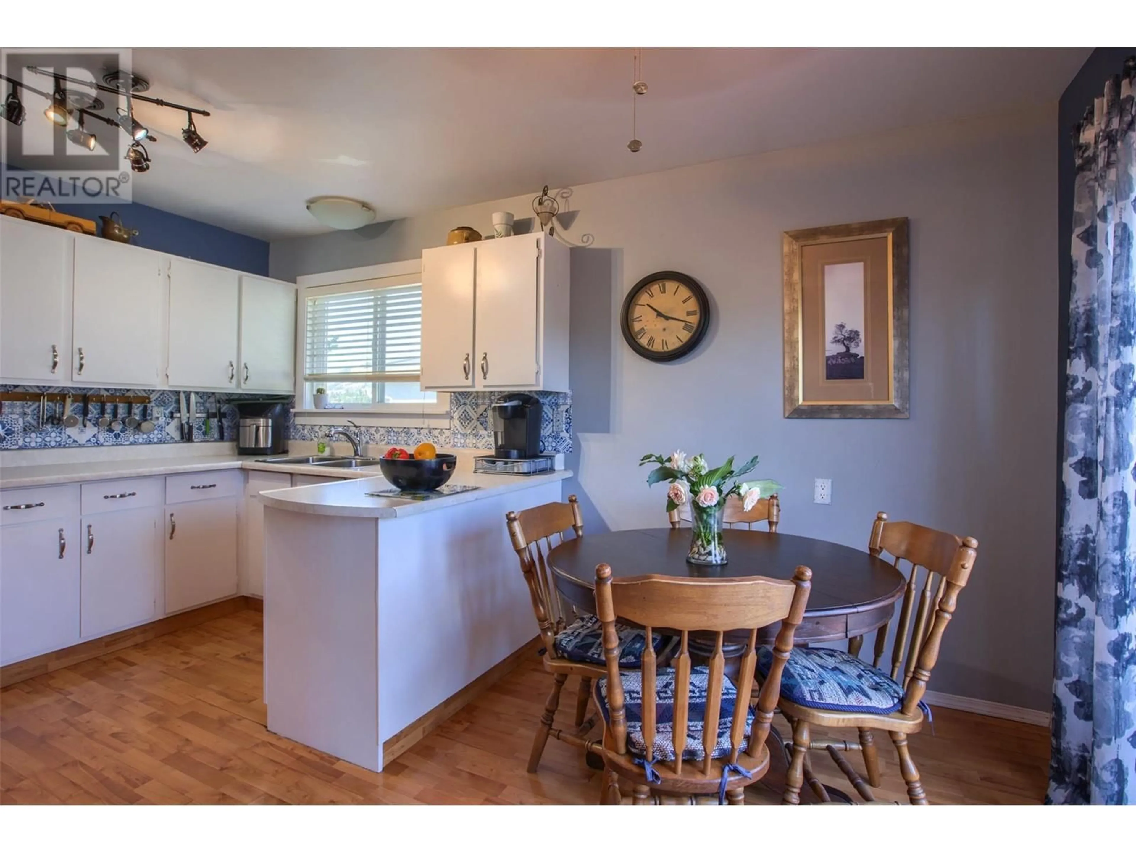 Open concept kitchen, wood/laminate floor for 2443 Margaret Road, West Kelowna British Columbia V4T1N6