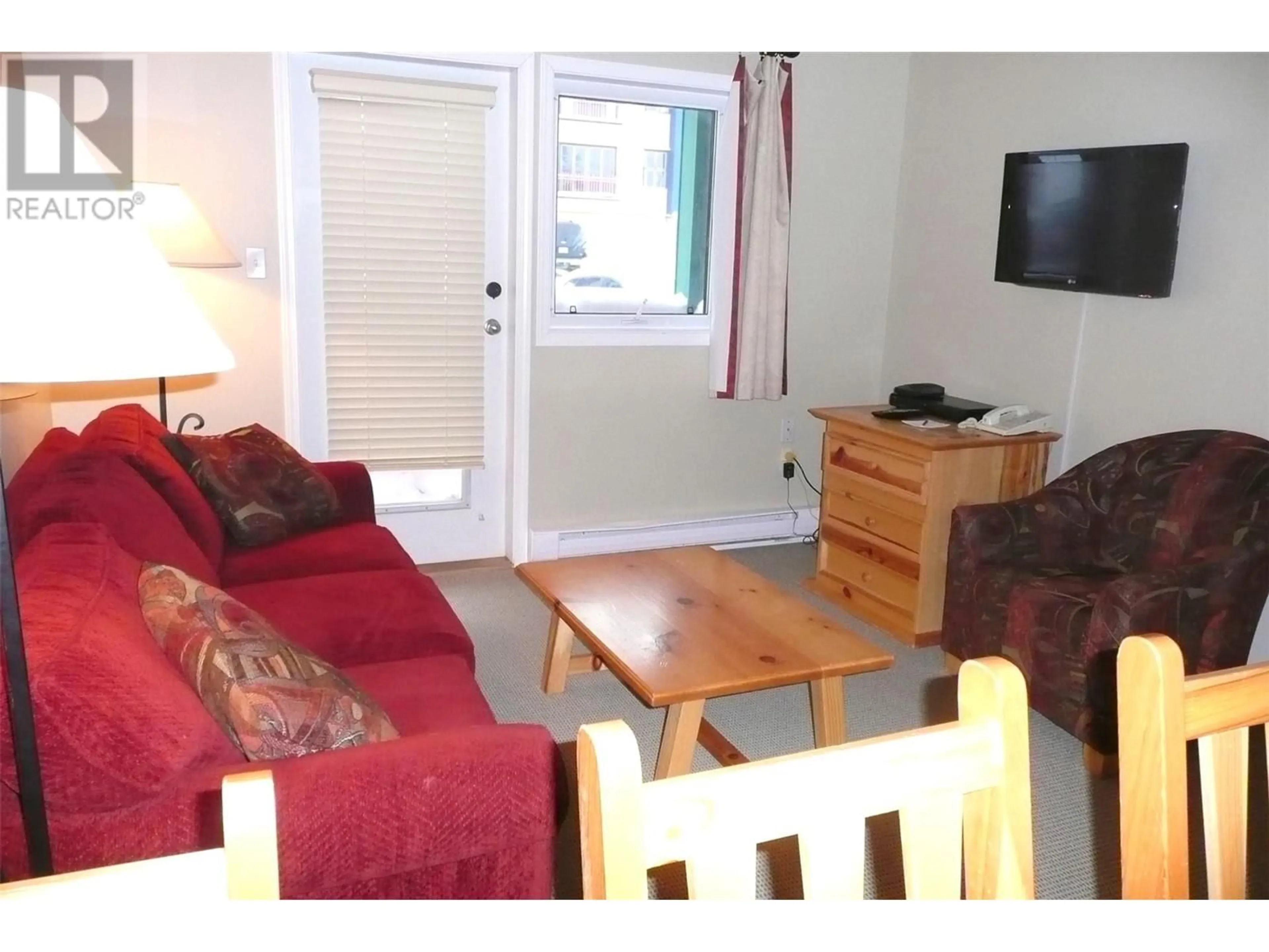 Living room with furniture, wood/laminate floor for 208 - 148 SILVER LODE LANE, Silver Star British Columbia V1B3M1