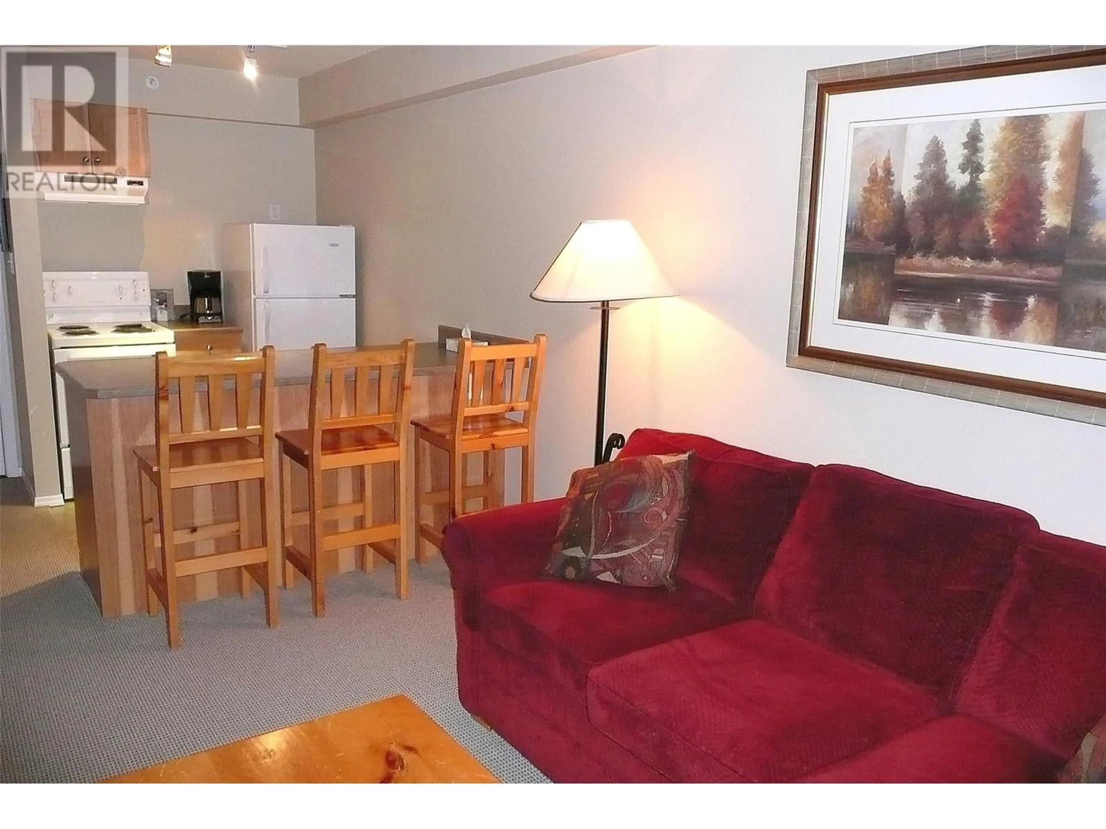 Living room with furniture, wood/laminate floor for 208 - 148 SILVER LODE LANE, Silver Star British Columbia V1B3M1