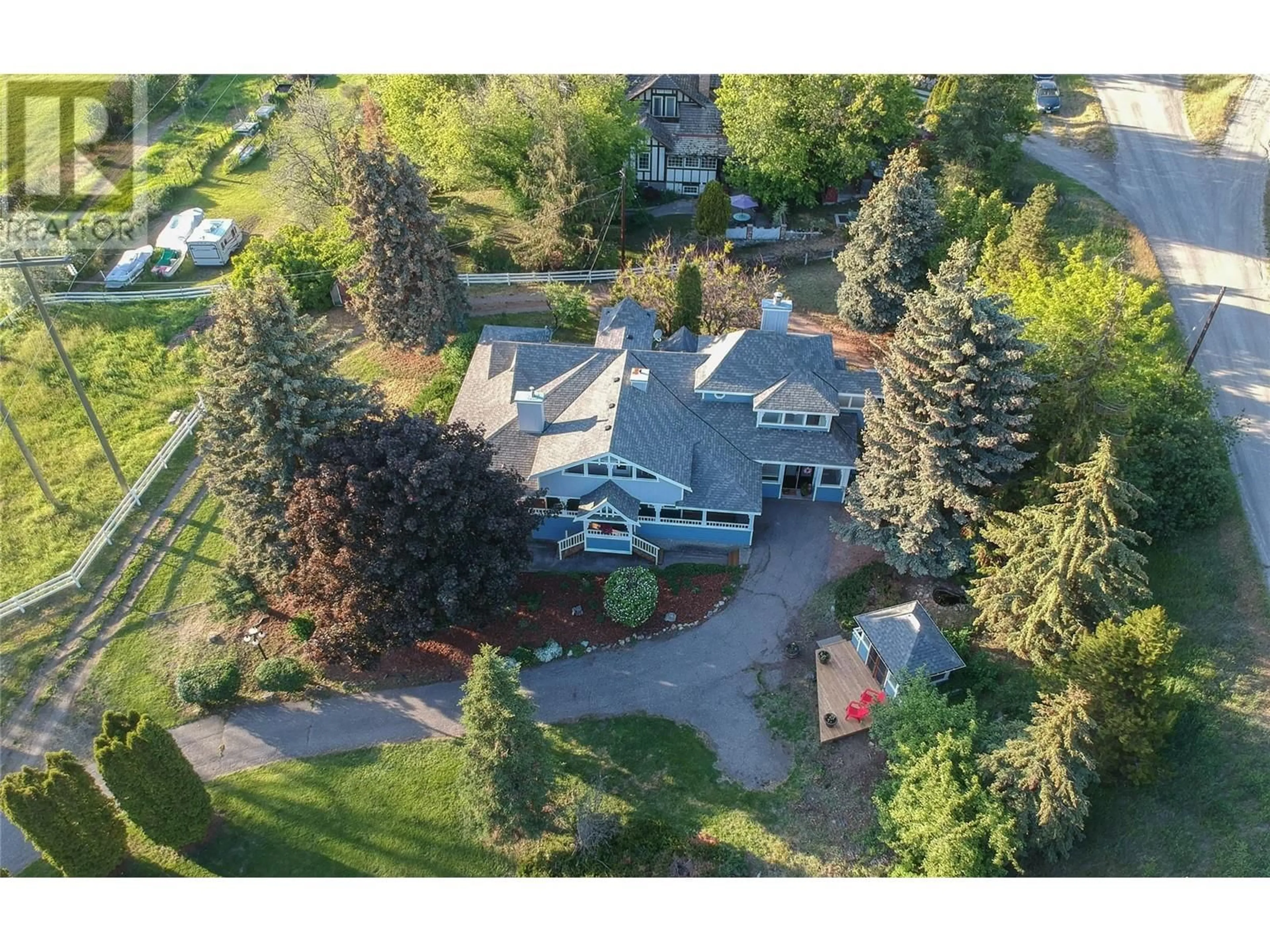 A pic from outside/outdoor area/front of a property/back of a property/a pic from drone, street for 6926 RUGG ROAD, Vernon British Columbia V1B3S9