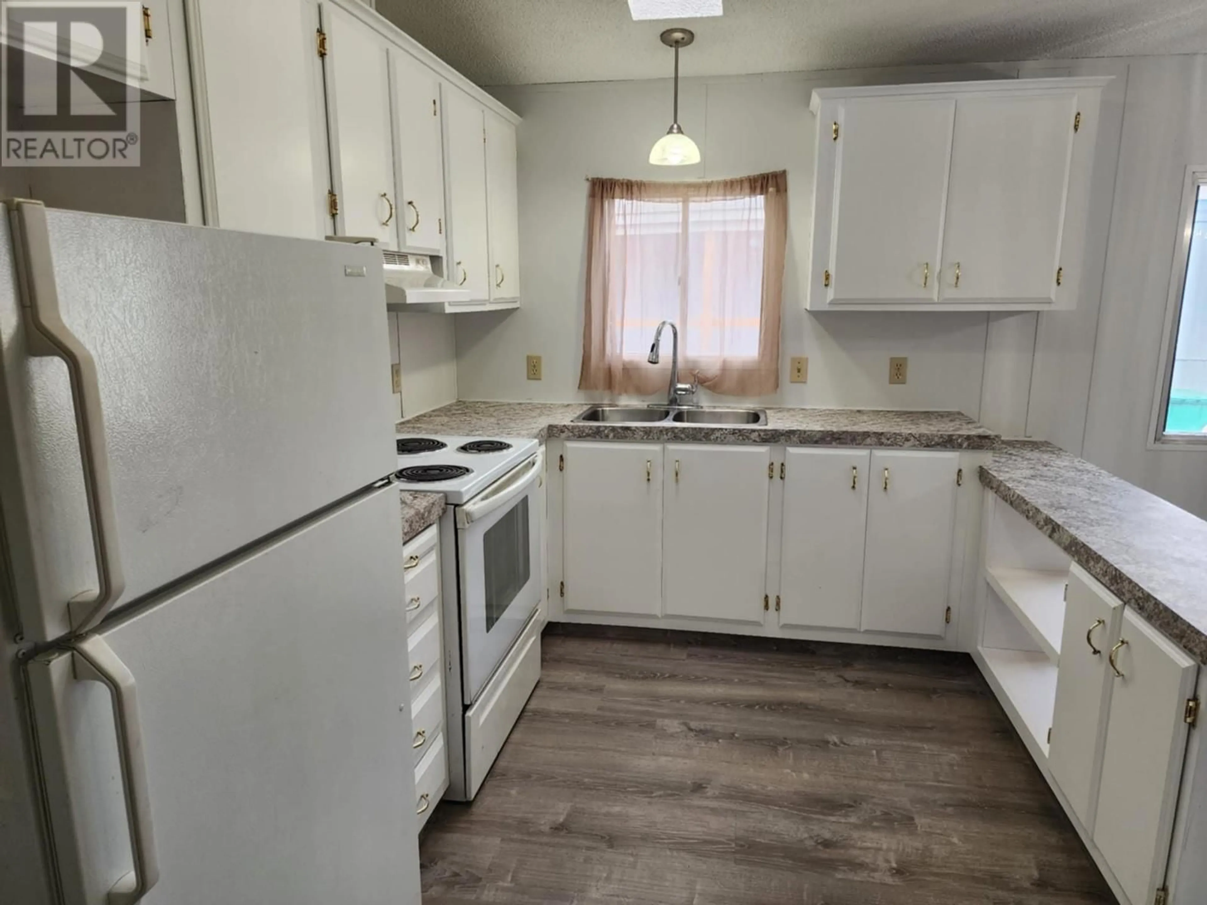 Standard kitchen, wood/laminate floor for 2313 Shuswap Avenue Unit# 32, Lumby British Columbia V0E2G0