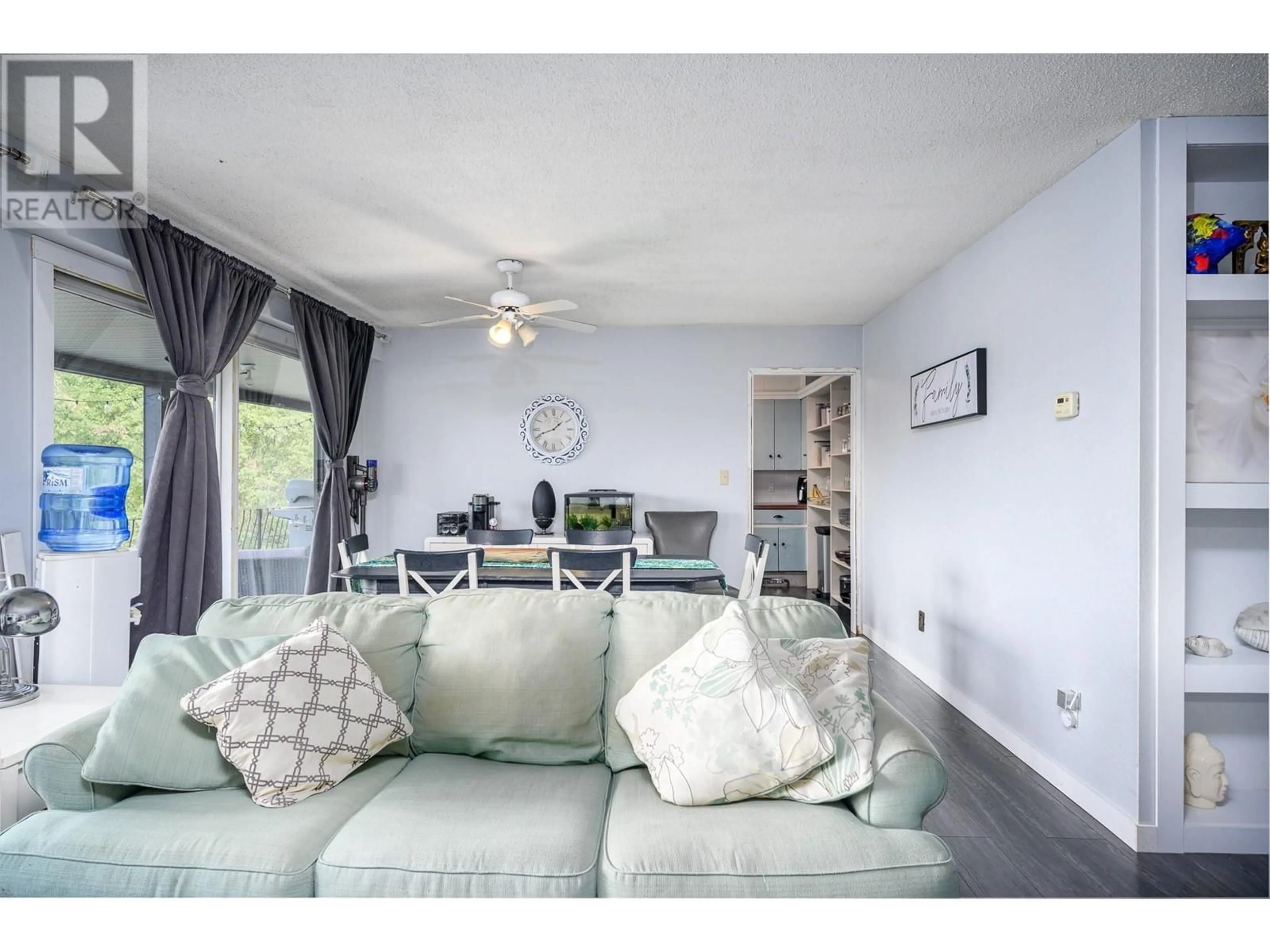 Living room with furniture, wood/laminate floor for 4006 Pleasant Valley Road, Vernon British Columbia V1T4M2