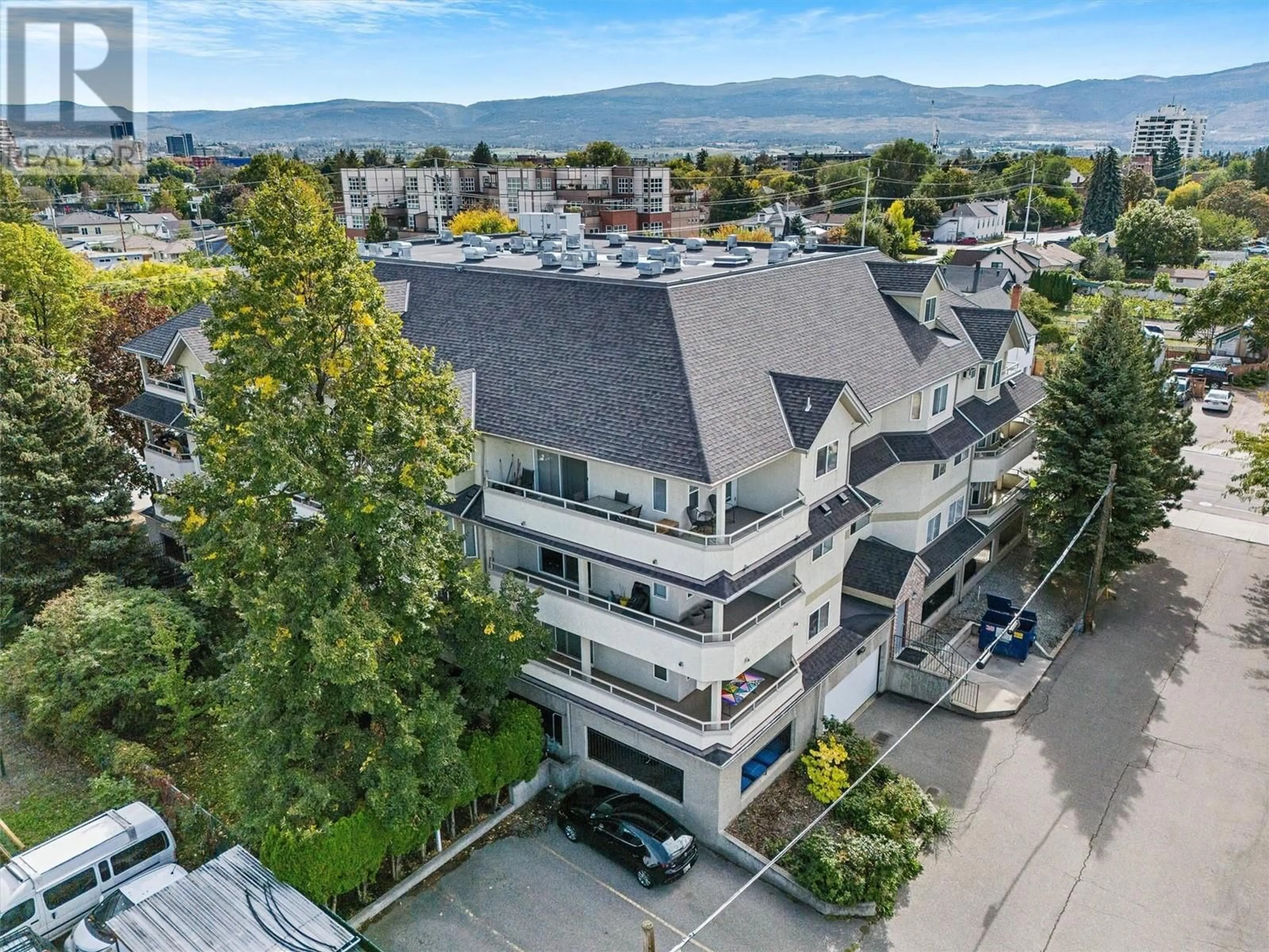 A pic from outside/outdoor area/front of a property/back of a property/a pic from drone, mountain view for 306 - 680 DOYLE AVENUE, Kelowna British Columbia V1Y9S2