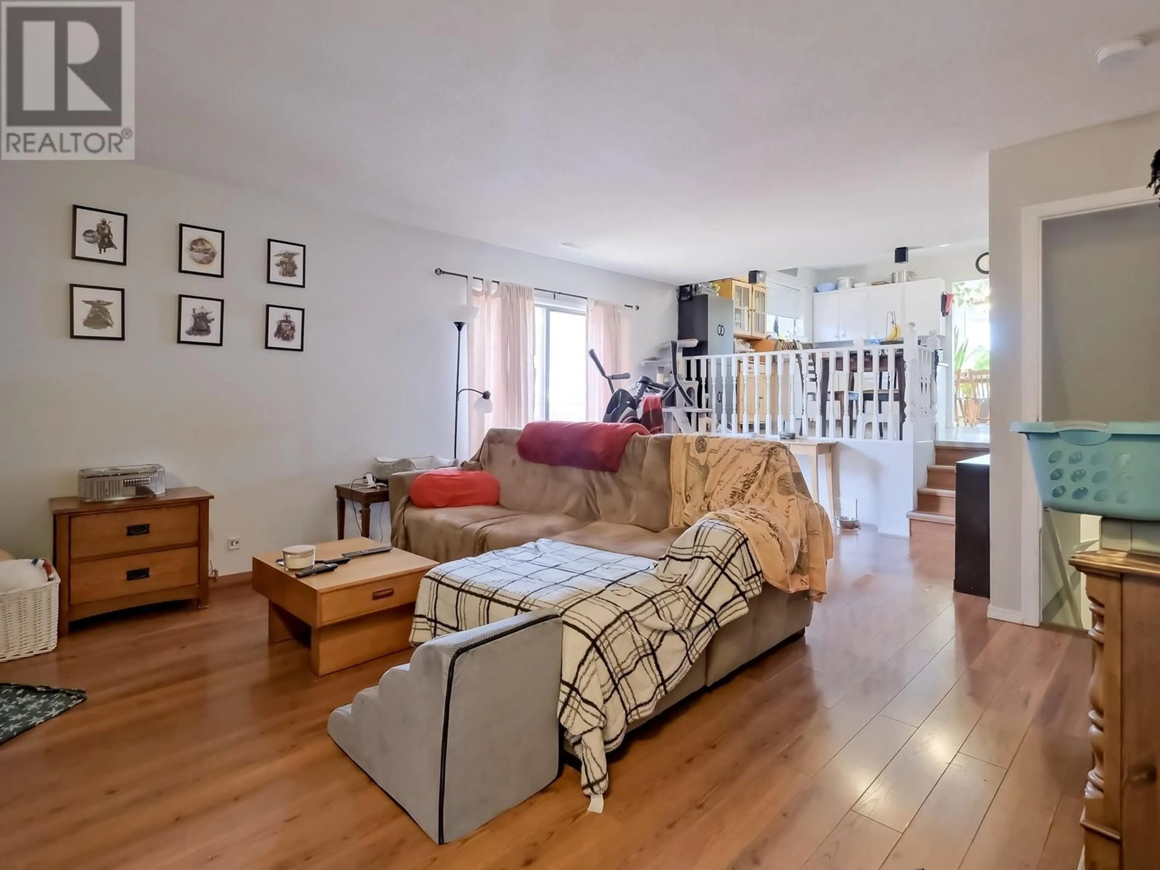 Living room with furniture, wood/laminate floor for 114 Blairmore Crescent, Penticton British Columbia V2A7C5