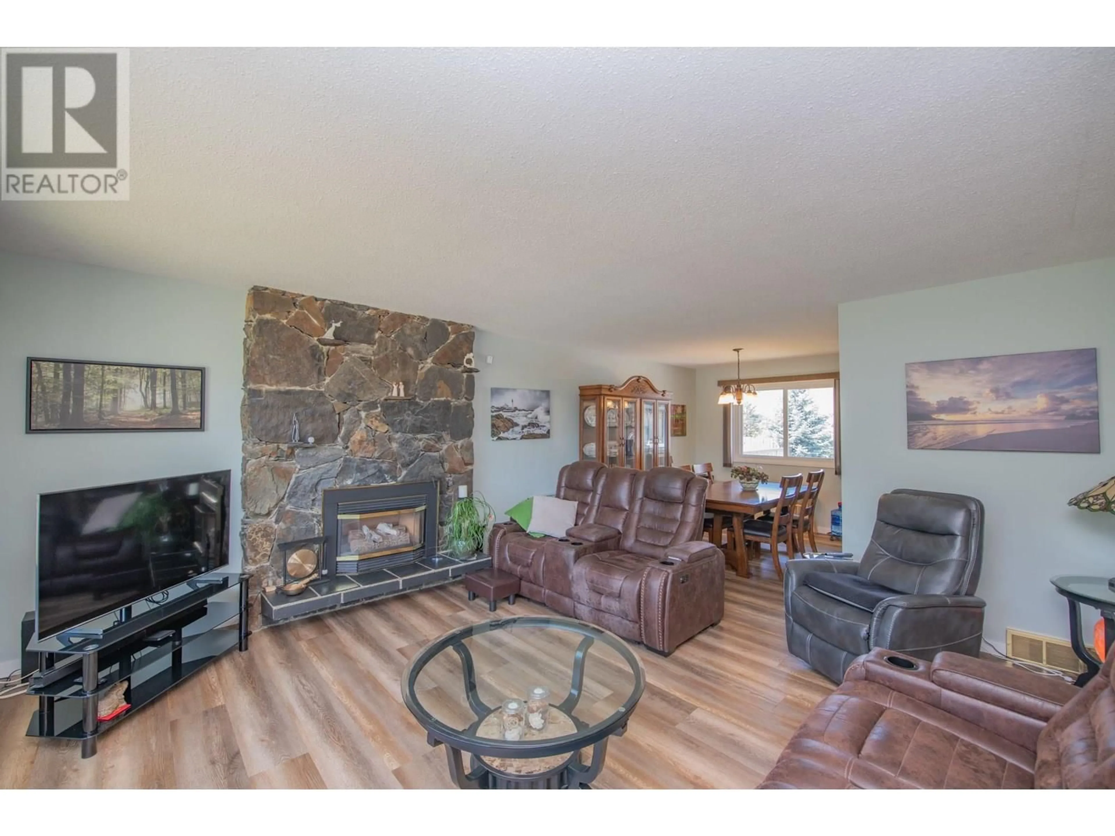 Living room with furniture, wood/laminate floor for 2112 40 STREET, Vernon British Columbia V1T7P2