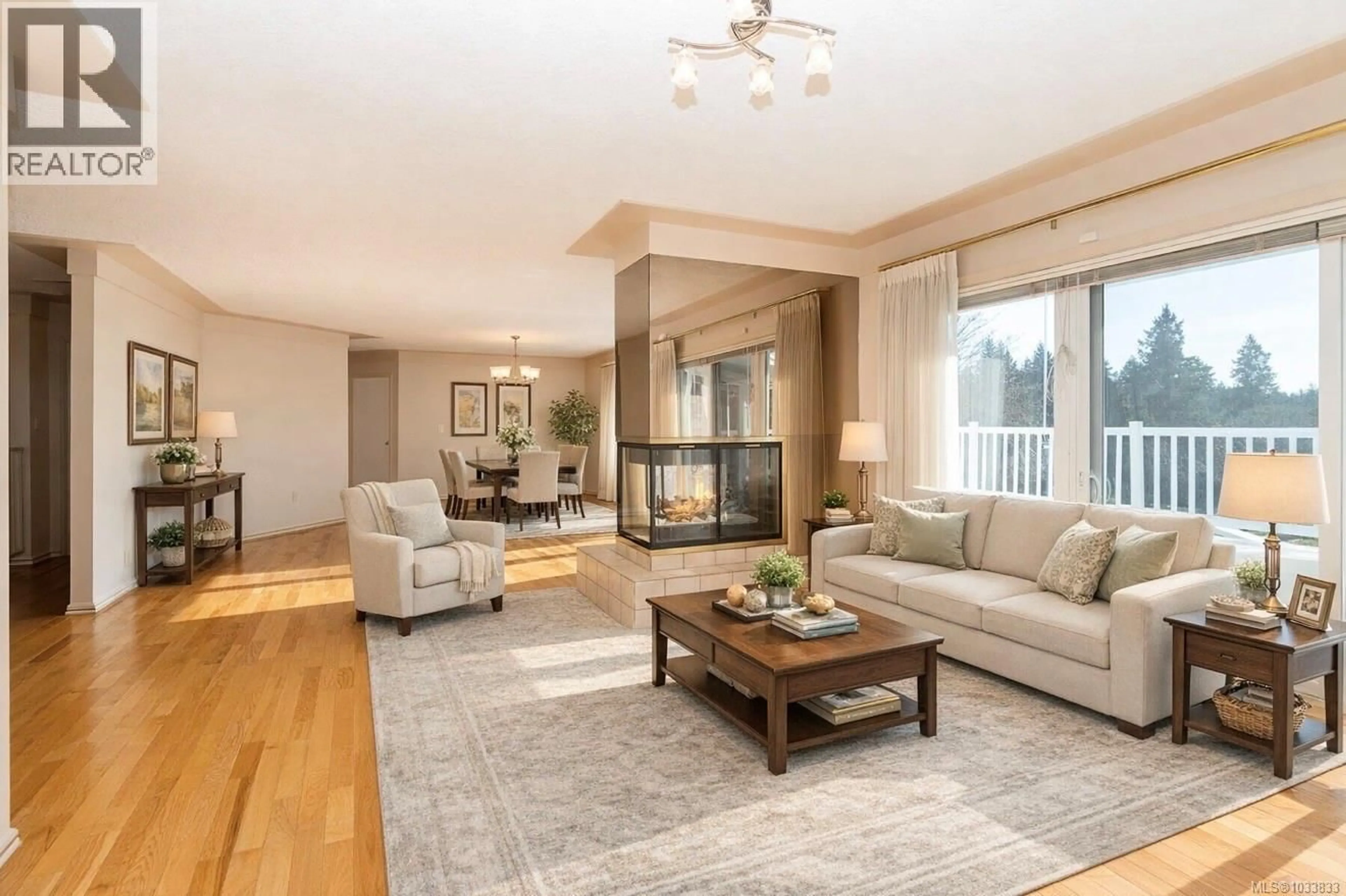 Living room with furniture, wood/laminate floor for 4569 BOULDERWOOD DRIVE, Saanich British Columbia V8Y3A5