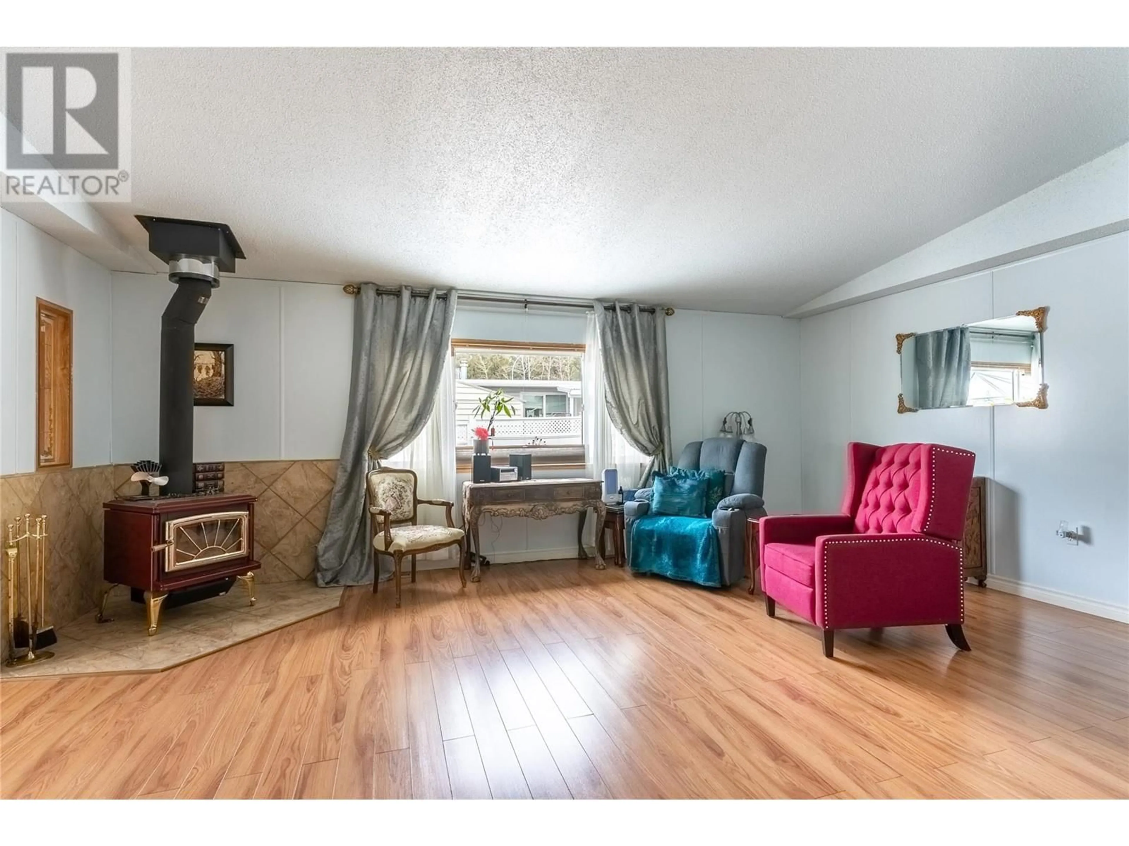 Living room with furniture, wood/laminate floor for 6 JASPER DRIVE, Logan Lake British Columbia V0K1W0