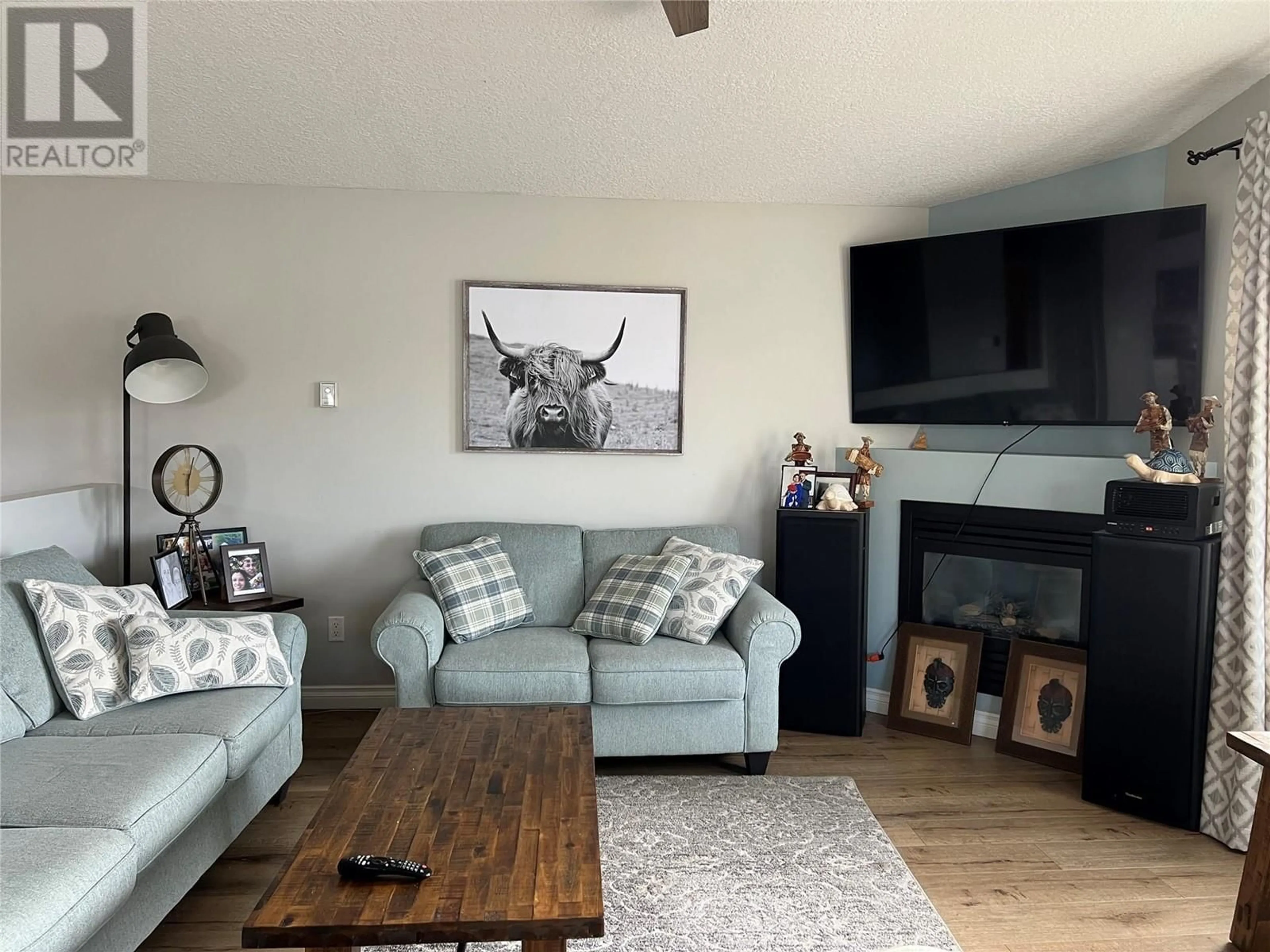 Living room with furniture, wood/laminate floor for 5207 40 STREET, Chetwynd British Columbia V0C1J0